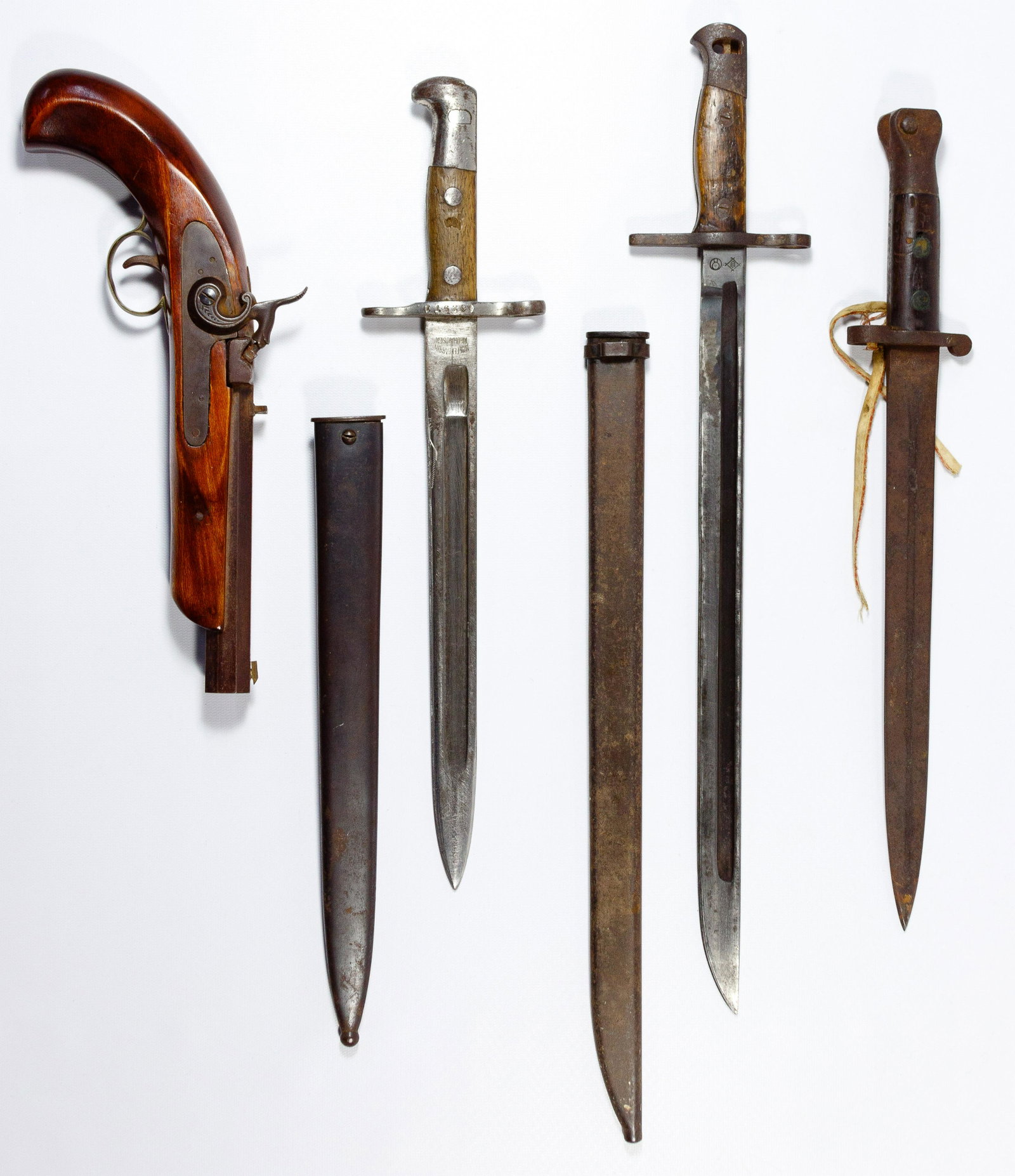 World War I and II Bayonet Assortment: World War I and II Bayonet Assortment (4) items including a German Waffenfabrik and sheath marked on blade, a Japanese Toyoda Jido Saisaki-jo KK and sheath, makers mark on blade and an English VR Wilk