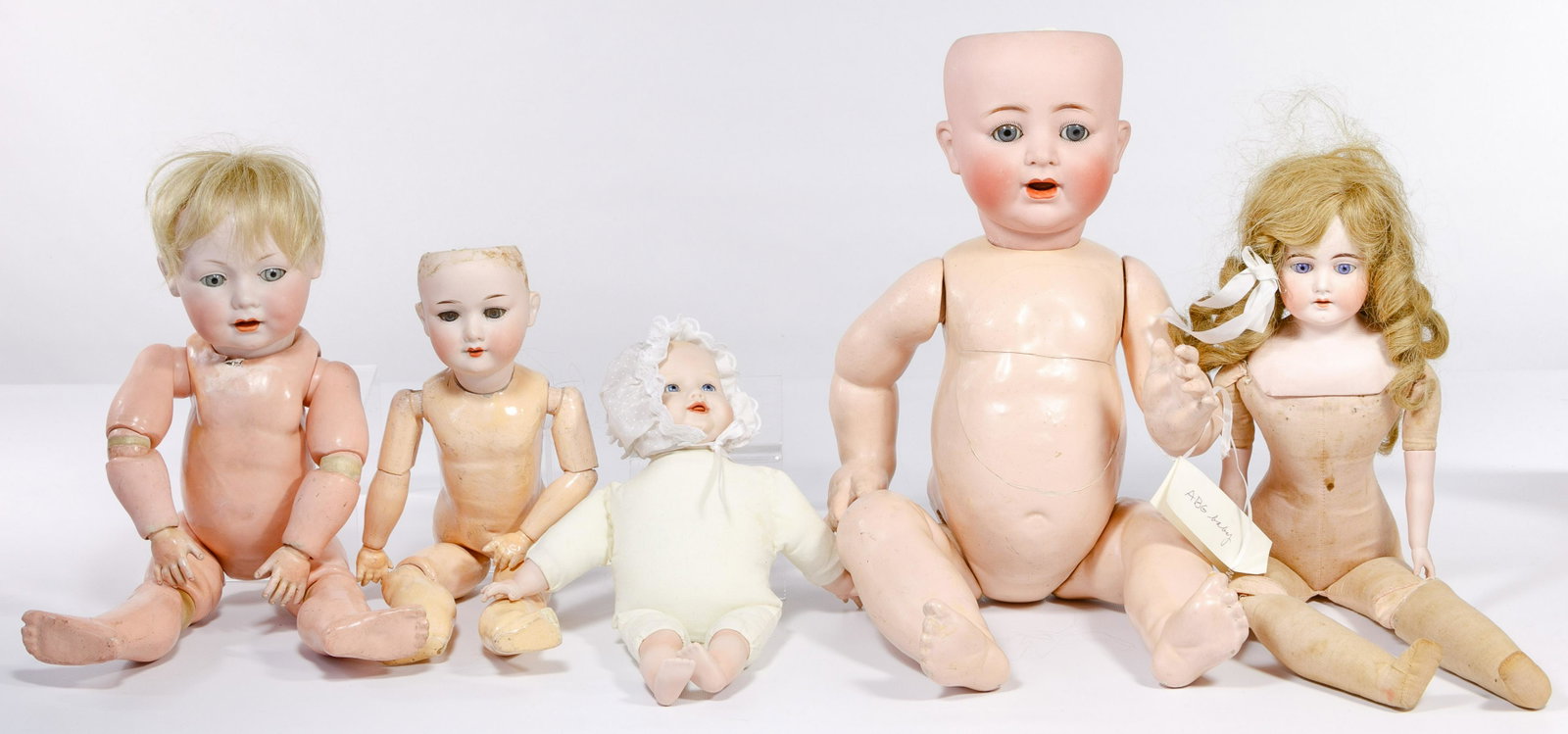 German Bisque Head Baby Doll Assortment: German Bisque Head Baby Doll Assortment (5) dolls including 22-inch / life size Alt, Beck & Gottschalck #1361/55 having painted face, sleep eyes, painted and synthetic eyelashes, open mouth exposing t