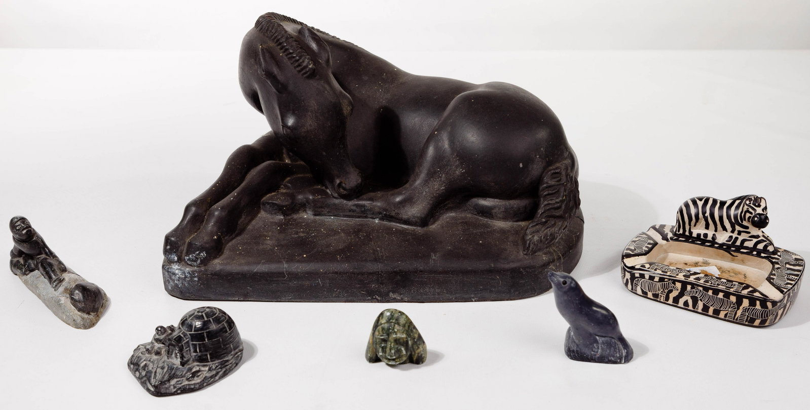 Heinz Warneke (American, 1895-1953) Sculpture: Heinz Warneke (American, 1895-1953) Sculpture 1948, carved stone horse, signed on back left corner of base; together with a zebra ashtray; (3) carved soapstone items including a figure, an igloo scene