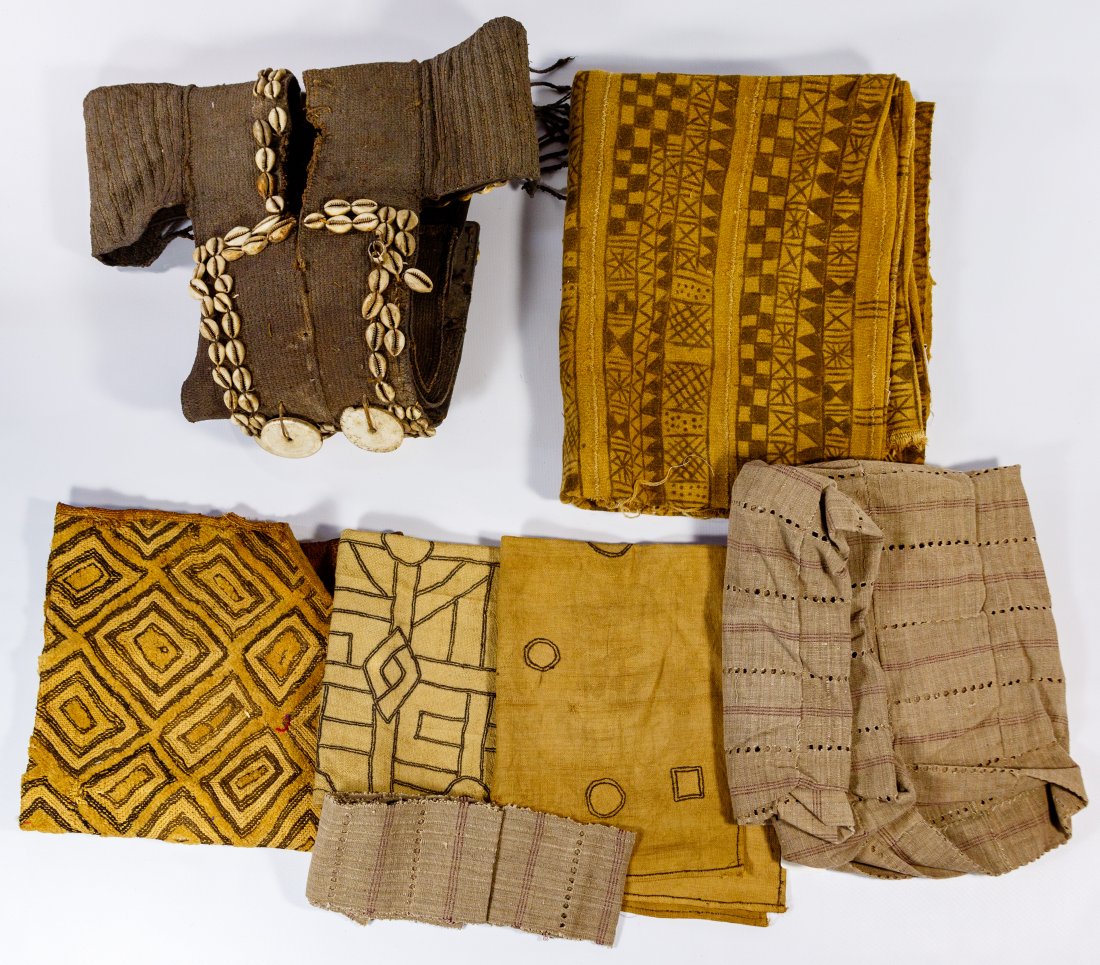 African New Guinea Textile Assortment: African New Guinea Textile Assortment (6) items including a tribal vest having cowrie, leather and woven attributes, woven strip jacket, examples of Senufa mudcloth, simple applique and a Kuba woven r