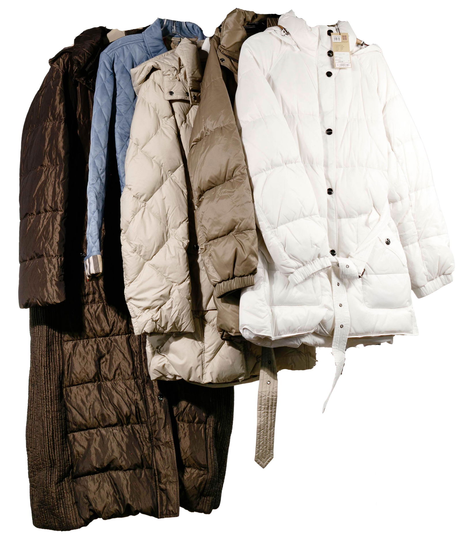 Burberry Winter Coat Assortment: Burberry Winter Coat Assortment (5) items including (4) goose down and nylon car coats in white and light, medium and dark brown; and a light blue double breasted quilted jacket; most with original ta