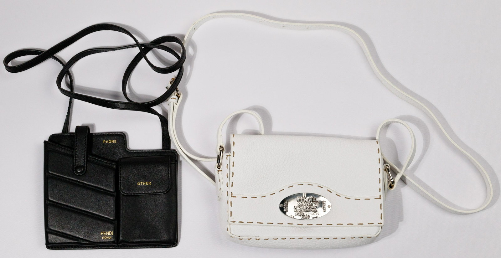 Fendi Handbag Assortment: Fendi Handbag Assortment (2) items including 'Selleria 1925' serial #49-27-13760, messenger bag, tan-stitched white calf leather having adjustable strap and silver-tone hardware, tan fabric lining and