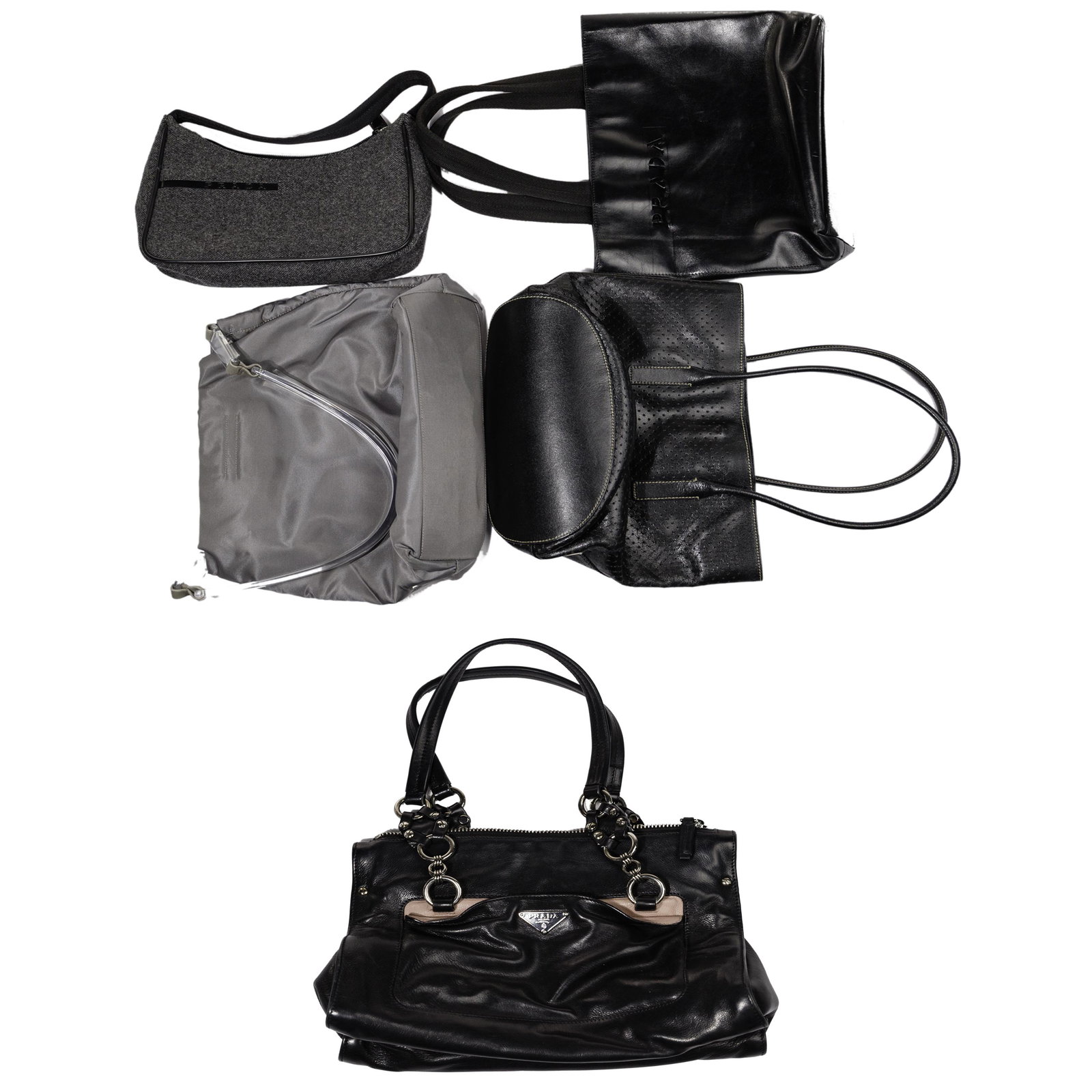 Prada Handbag Assortment: Prada Handbag Assortment (5) items including a gray nylon 'Tessuto' having a lucite handle and black signature interior (10-inches tall by 12.75-inches wide by 3.25-inches deep); black perforated soft