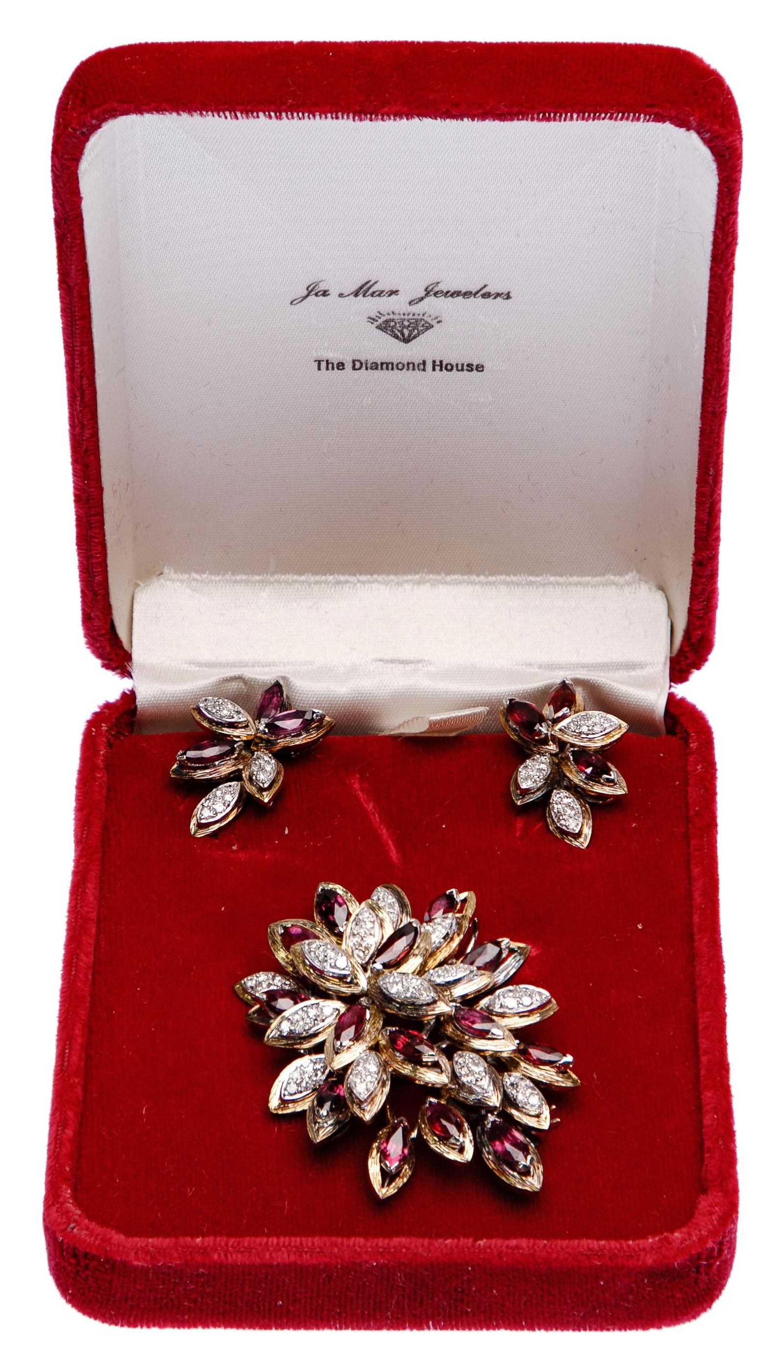 Mixed Metal, Ruby and Diamond Jewelry Suite: Mixed Metal, Ruby and Diamond Jewelry Suite Brooch and clip earrings having flower petals adorned with marquise cut rubies and cluster set round cut diamonds; with a storage case Length: 2 inches, Wid