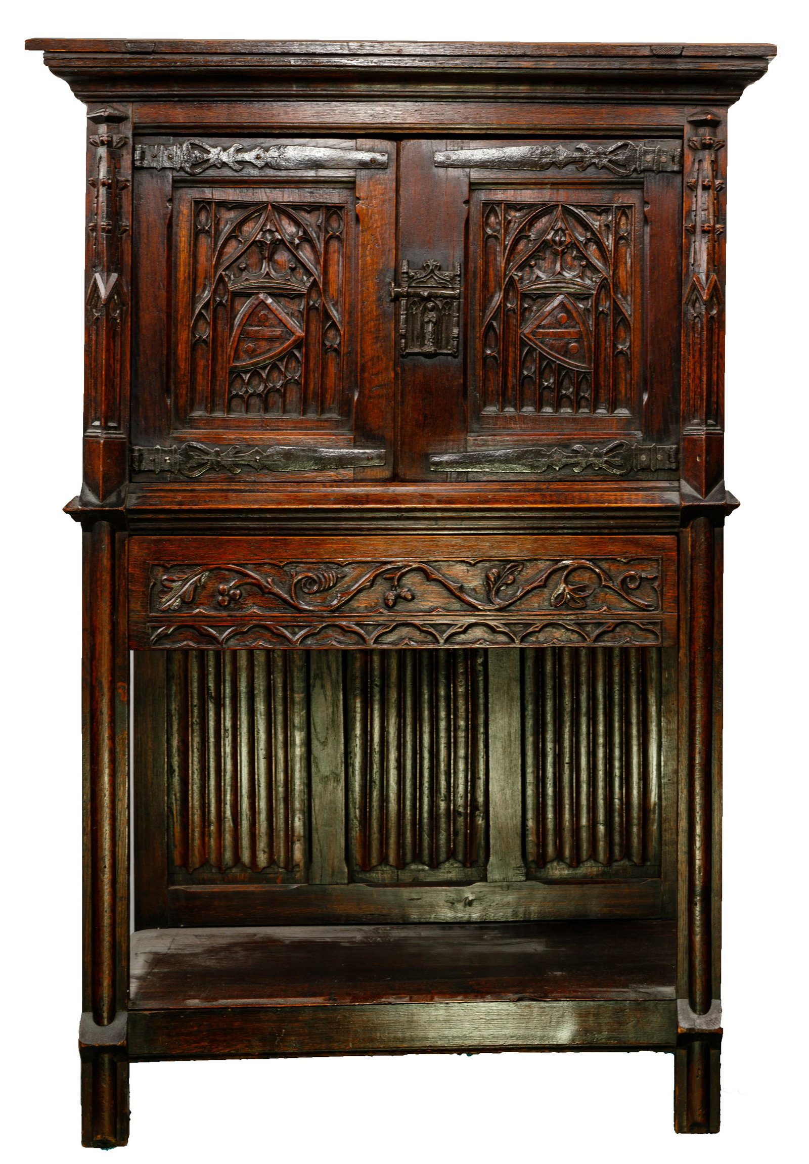 Gothic Revival Carved Wood Cabinet: Gothic Revival Carved Wood Cabinet Having flip up top to reveal a hidden compartment, (2) half doors over a full width drawer over an open shelf; cast metal hinges and slide lock; back stamped 'Made i