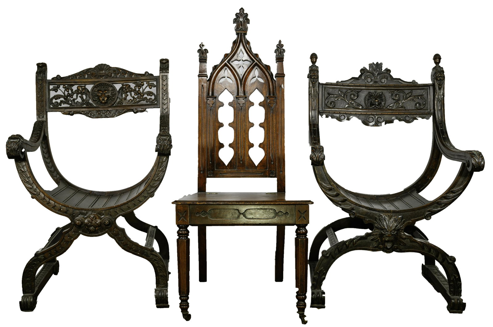 Gothic Revival Carved Wood Chair Assortment: Gothic Revival Carved Wood Chair Assortment (3) chairs including (2) carved arm chairs having lions on the rails and arms with floral and acanthus leaves overall on Savonarola style frames; and a cath
