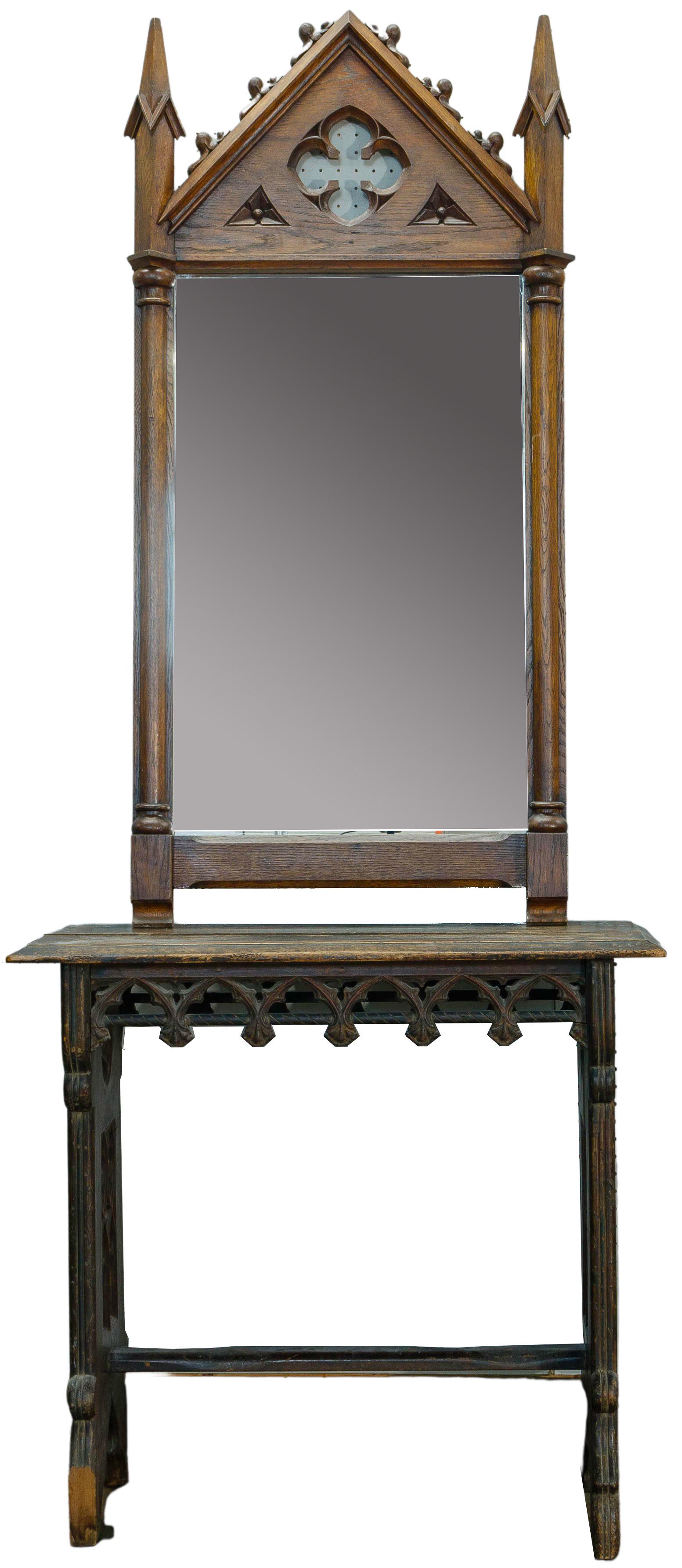 Gothic Revival Cathedral Hall Table and Mirror: Gothic Revival Cathedral Hall Table and Mirror (2) items including a table having carved skirts and ends with a floral painted top; and a mirror having carved top and columns flanking the mirror openi