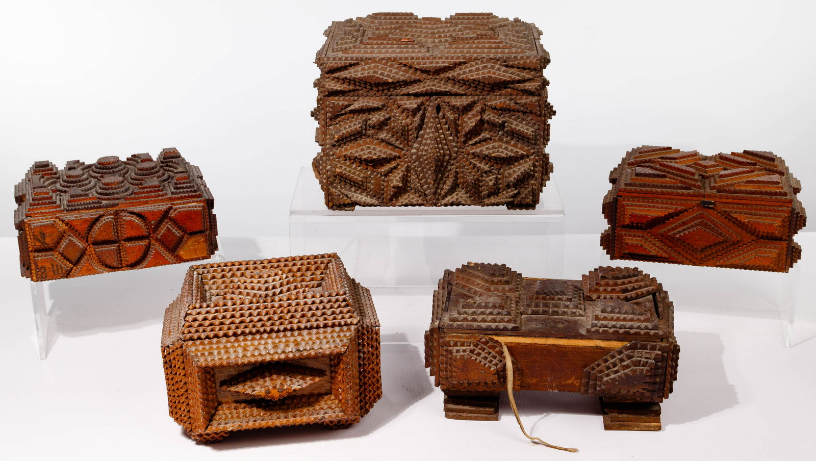 Tramp Art Box Assortment: Tramp Art Box Assortment (5) items including (4) lidded cigar boxes and a taller box having an inner tray; all whittled, notched and assembled in layers with geometric patterns; (3) having hinged lids