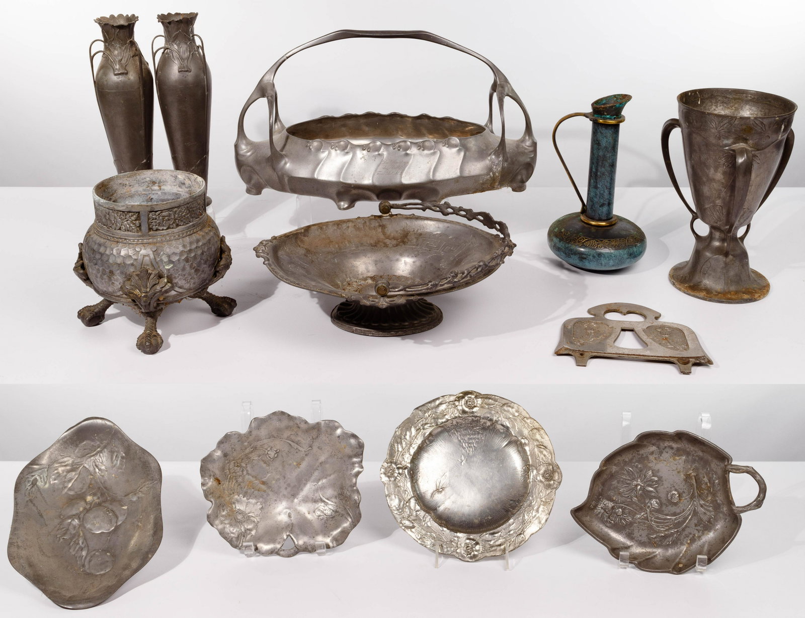 Kayserzinn Pewter Object Assortment: Kayserzinn Pewter Object Assortment (8) 'Kayserzinn' embossed Art Nouveau style serving plates, three-handled pedestal loving cup, oval footed basket inscribed and dated '22 Mar 1909' and pair of vase