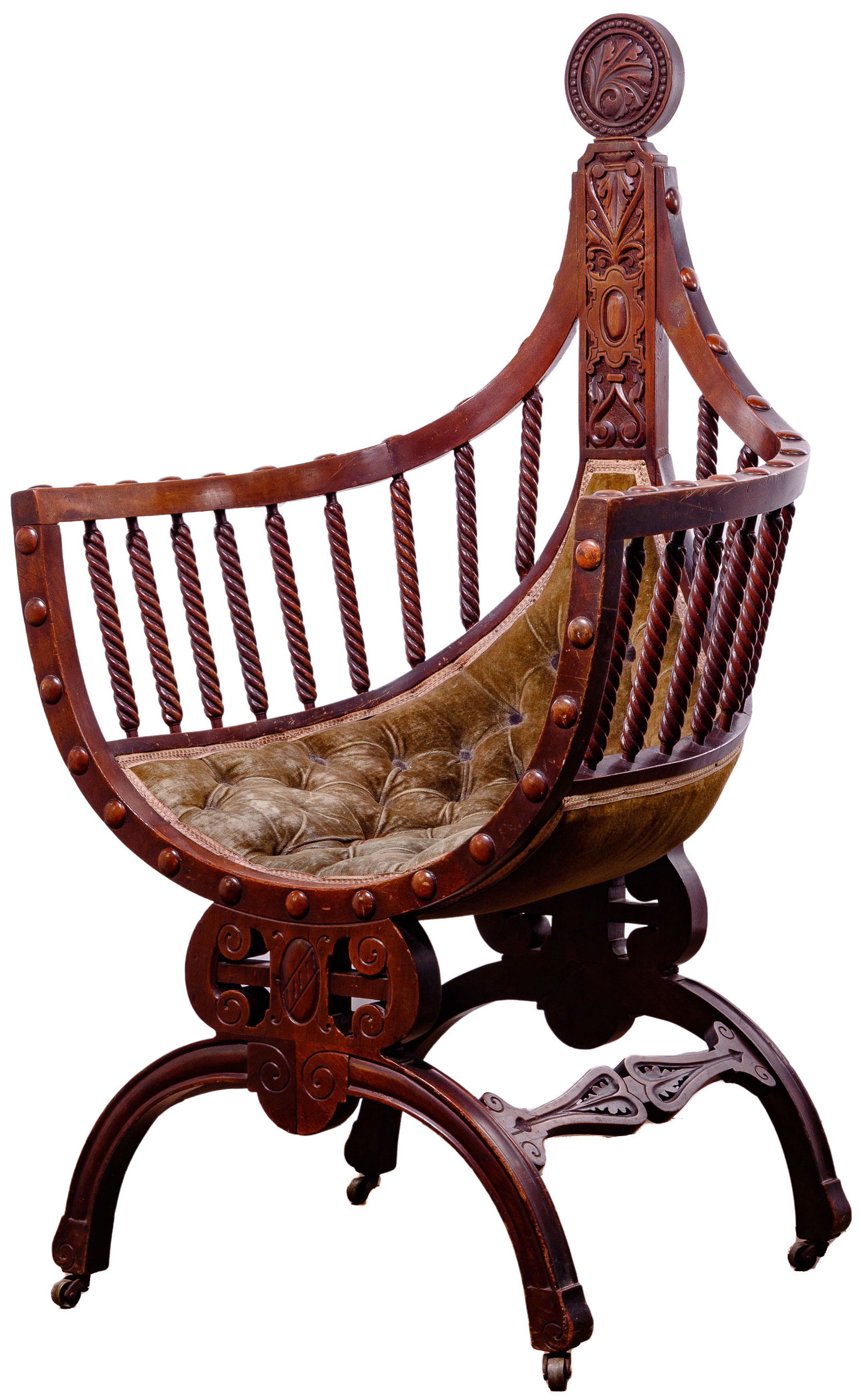 Gothic Renaissance Revival Velvet Curule Chair: Gothic Renaissance Revival Velvet Curule Chair Intricately carved mahogany having a tufted seat that slants up towards the back; curved bridge front and back legs on small wheels; tight barley twist s
