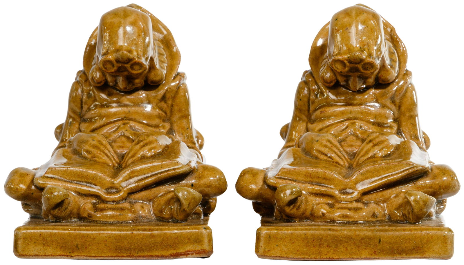Fulper 'Sleepy Reader' Bookends: Fulper 'Sleepy Reader' Bookends Early 20th century, having a mottled brown glaze, each depicting a male figure sleeping in the seated position with spectacles on his head; both marked 'Fulper' on the 