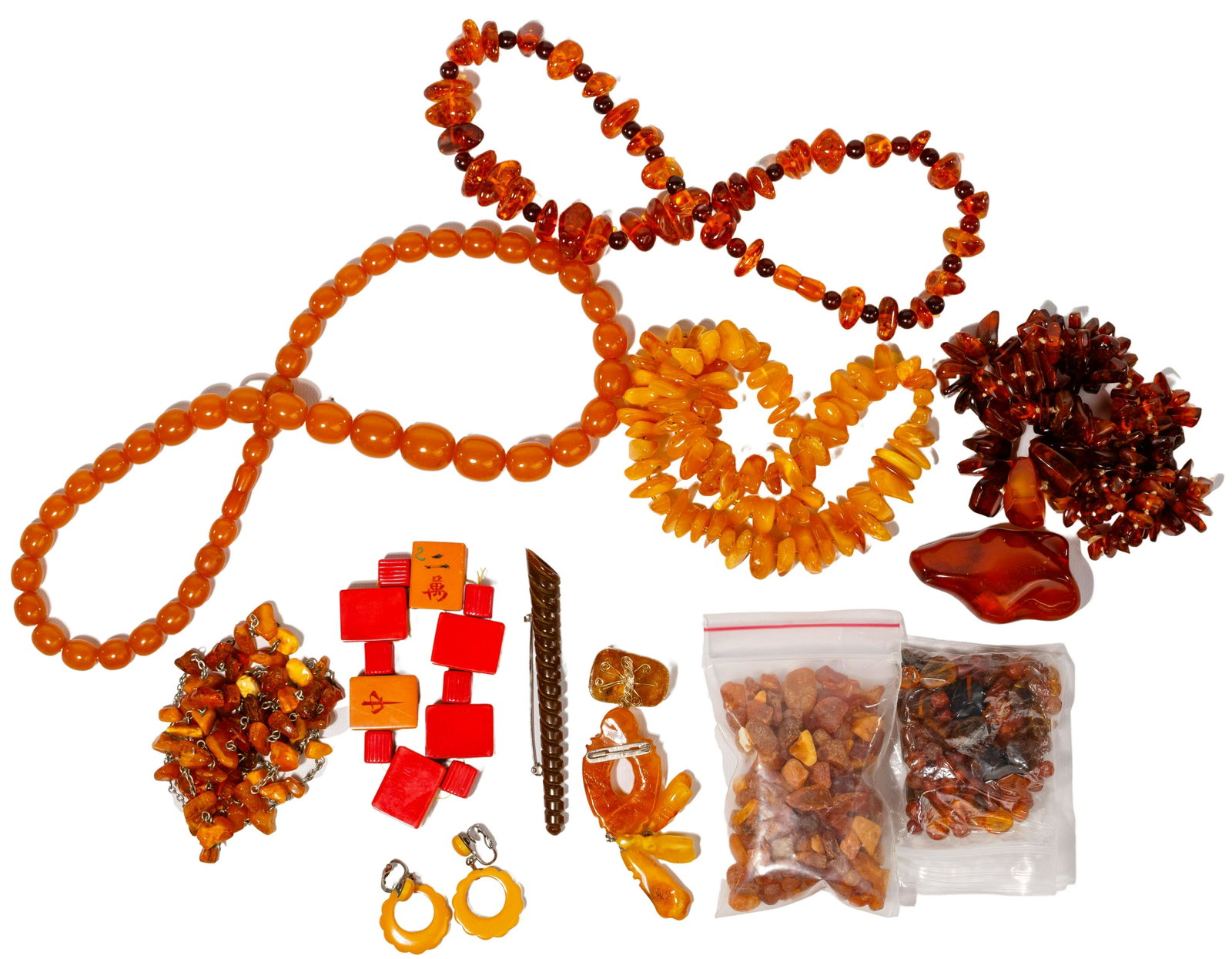 Amber and Bakelite Jewelry Assortment: Amber and Bakelite Jewelry Assortment Including (5) necklaces, a pendent, a pin and ring; (3) pieces of Bakelite including a Mahjong tile bracelet, a pair of earrings and a spiral pin; together with p