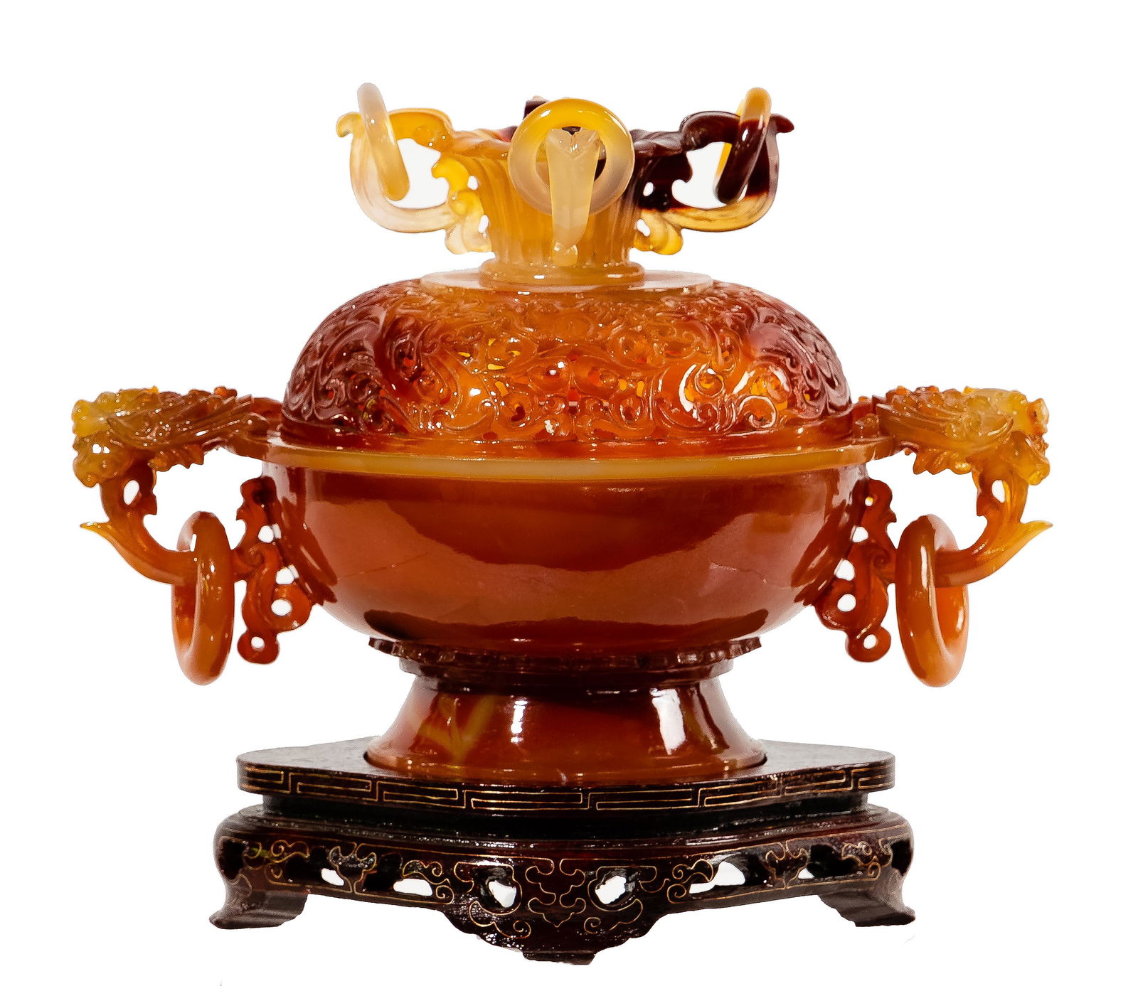 Chinese Carved Carnelian Agate Censer: Chinese Carved Carnelian Agate Censer Rust colored footed urn having an intricate pierced round cover surmounted by a finial having rings and (2) foo dog handles holding rings; on a wood base Property