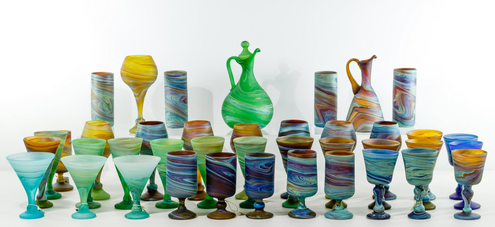 Phoenician Style Glass Assortment: Phoenician Style Glass Assortment (40) items including (2) pitchers, (4) tumblers, (12) stemmed cocktail, (8) wine goblets, (5) stemmed water glasses, (3) cocktail and (6) stemmed goblets; all having 