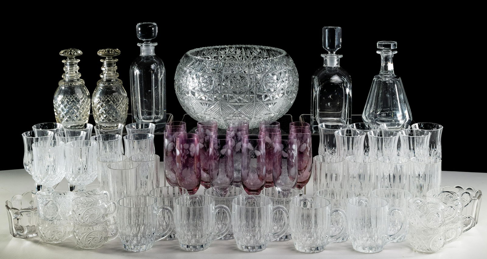 Crystal and Glassware Assortment: Crystal and Glassware Assortment (66) items including (2) signed Orrefors crystal decanters; signed Baccarat decanter; (2) unsigned decanters; a large cut crystal punch bowl, (10) punch glasses; (14)
