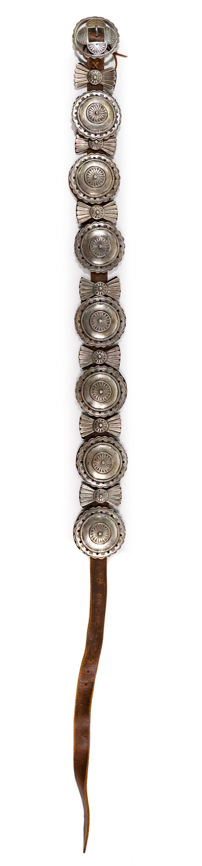 Arnold Goldstein Sterling Silver Concho Belt: Arnold Goldstein Sterling Silver Concho Belt 1989, signed on reverse of buckle, having (7) 3-inch round conchos and (7) 2.25-inch tall by 1.25-inch wide butterfly style conchos in between, a round bel