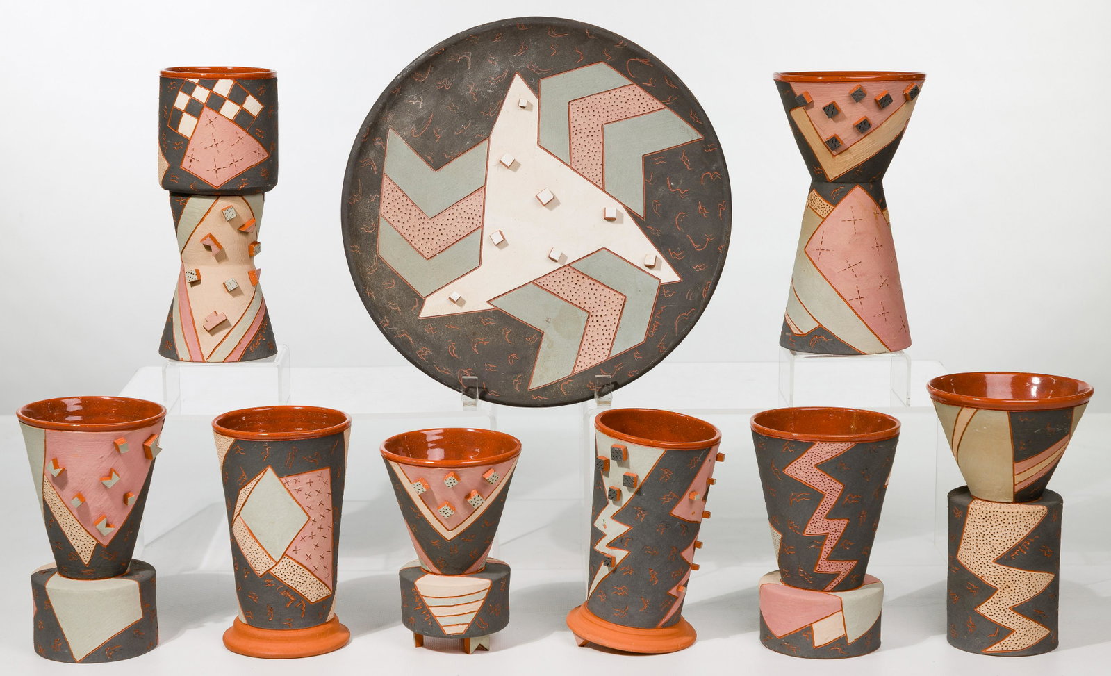Lynne Chytilo (American, 20th-21st Century) Pottery: Lynne Chytilo (American, 20th-21st Century) Pottery Assortment (9) red ware items including (8) beaker vases and a plate, having a Postmodern / Southwest character employing matte glazed earth tones h