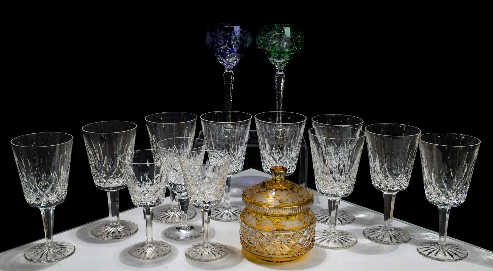 Waterford Crystal Stemware: Waterford Crystal Stemware (12) 'Lismore' faceted stemmed glasses including (9) water goblets and (3) white wines, marked on undersides; together with (2) cut to clear hock wine glasses and a cut to c