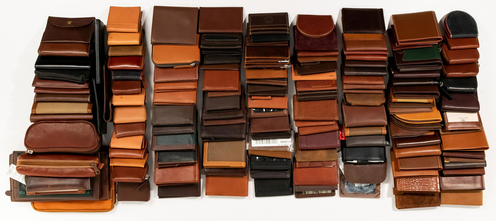 Men's Leather Assortment: Men's Leather Assortment Approximately (150) items including wallets, pen holders, note pads, coin purses, credit card holders, and pouches; makers including Tumi, Coac