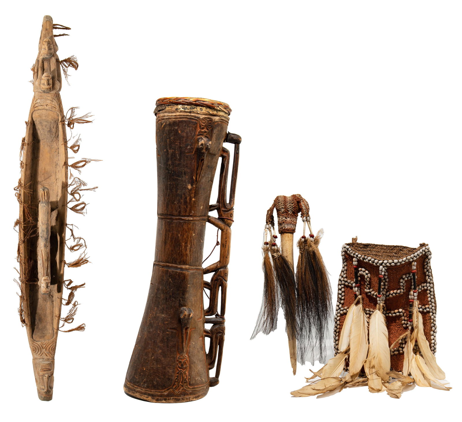 Papua New Guinea Assortment: Papua New Guinea Assortment (4) items including a Kamoro peoples 'eme' hourglass shaped drum carved from a single block of wood having an animal shaped integrated handle with decorative carving and re