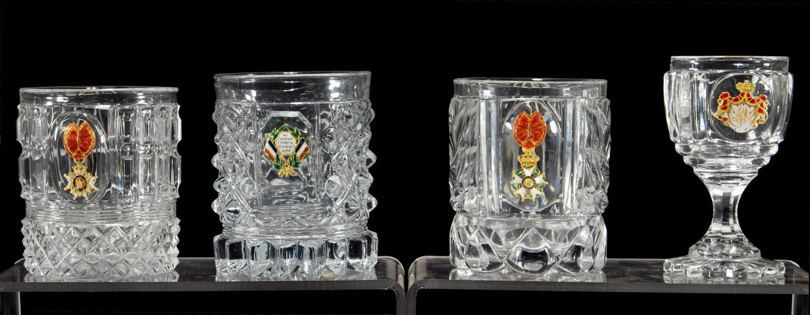 (Attributed to) Baccarat Cut Glass Tumblers: (Attributed to) Baccarat Cut Glass Tumblers (2) cut glass tumblers having enclosed foil emblems for the Legion of Honor; together with an enclosed foil Civic Courage emblem and an (attributed to) St. 