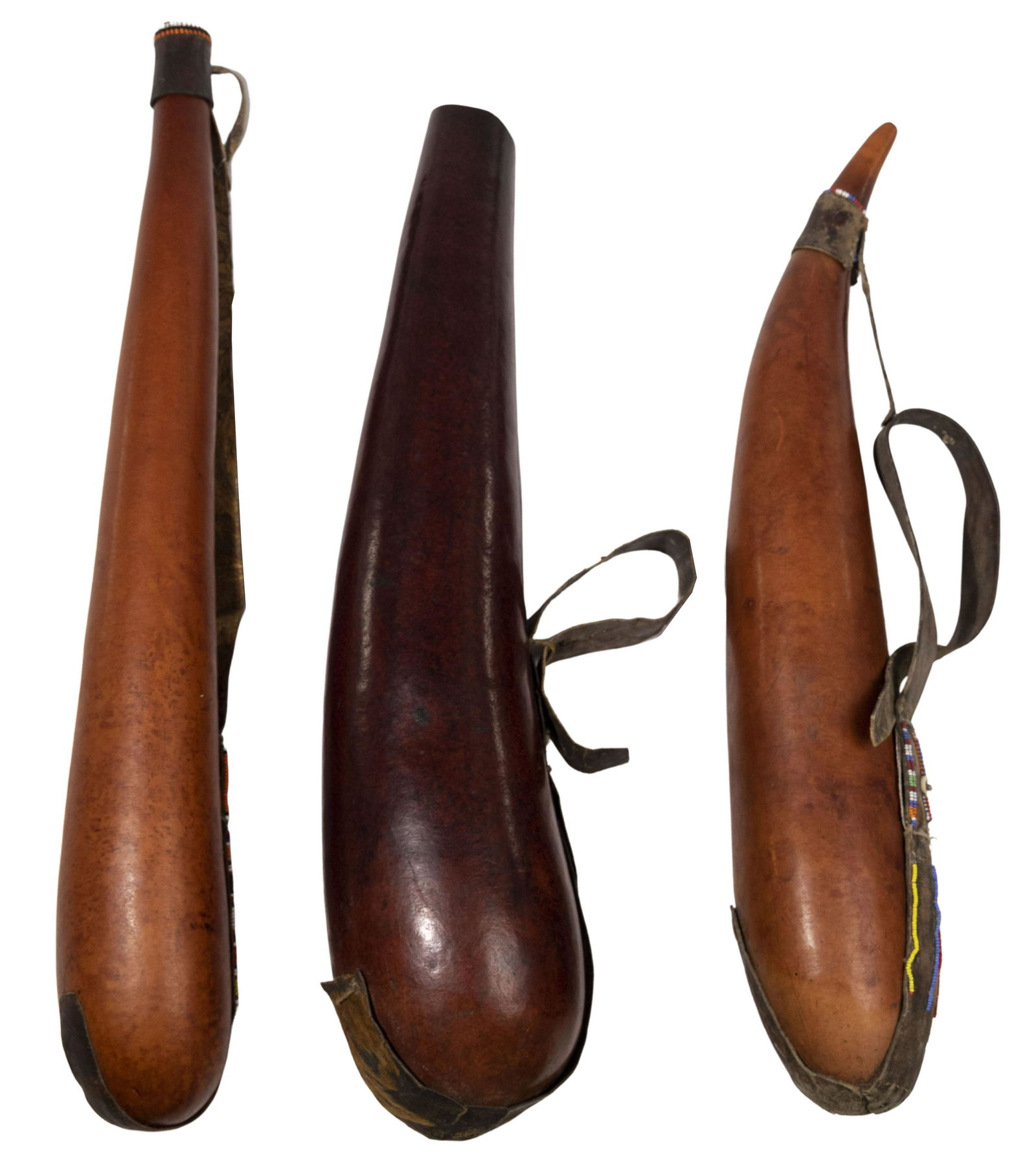 East African Gourd Flask Assortment: East African Gourd Flask Assortment (3) items including (2) having lids; each having bead work, shells and animal hide straps Property from: a Chicago, Illinois estate Height: 24 inches, Diameter: 3 3
