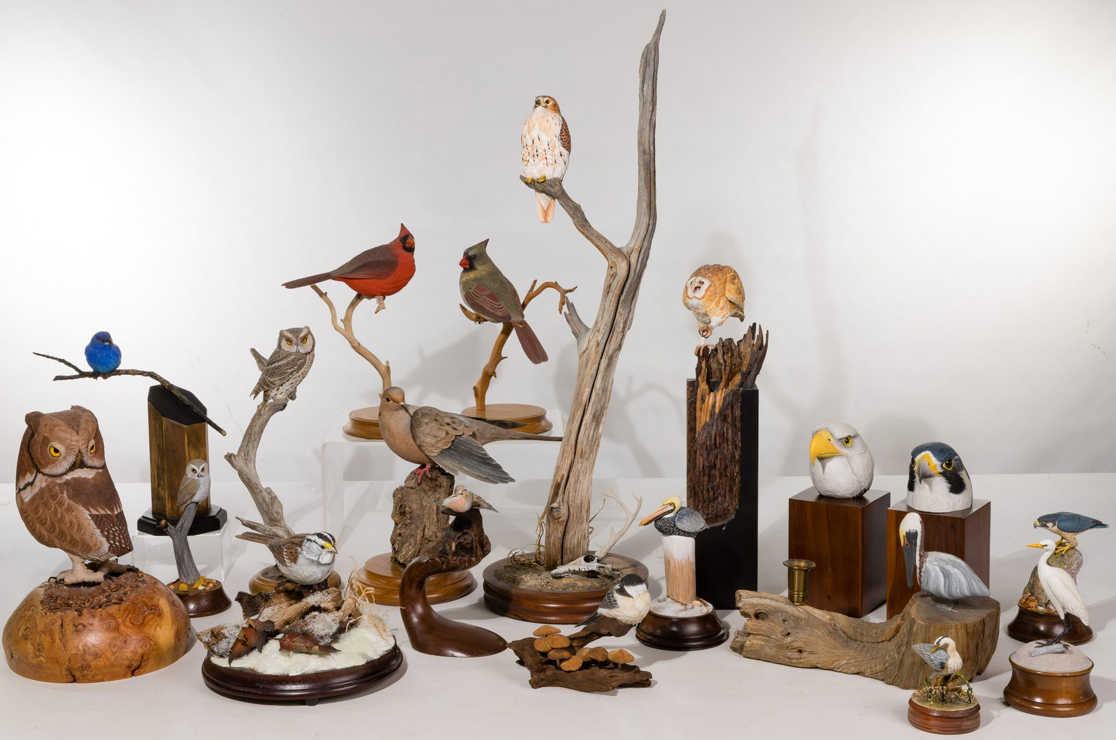 Carved Wood Avian Figurine Assortment: Carved Wood Avian Figurine Assortment (19) items including birds in various shapes and sizes, on branches and bases, most signed 'Bob Allen', 'Nanette Rozhon' Property from: a Lemont, Illinois estate 