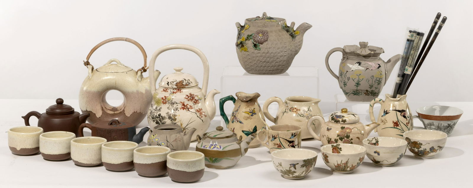 Asian Porcelain and Pottery Assortment: Asian Porcelain and Pottery Assortment (13) items including a 5-piece enamel on white porcelain tea set; a 7-piece white and brown glazed pottery tea set; (4) enamel on bisque Banko ware teapots; (2)