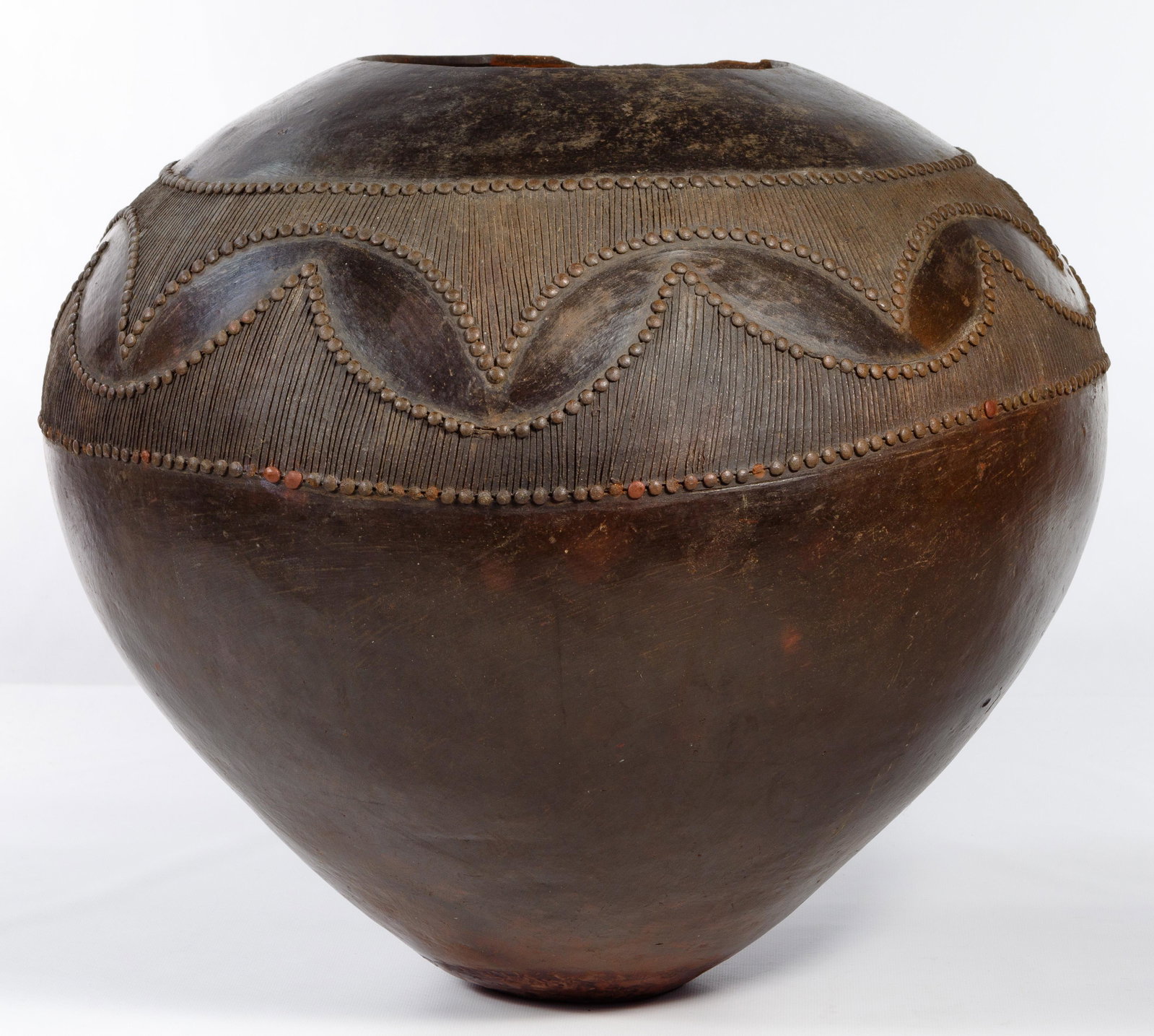 Mncane Nzuza (Zulu, b.1950) 'Ukhamba' Vessel: Mncane Nzuza (Zulu, b.1950) 'Ukhamba' Vessel Contemporary, hand-crafted clay beer-serving vessel with incised and applied design; gallery card showing the piece Provenance: from the estate of an Oak P