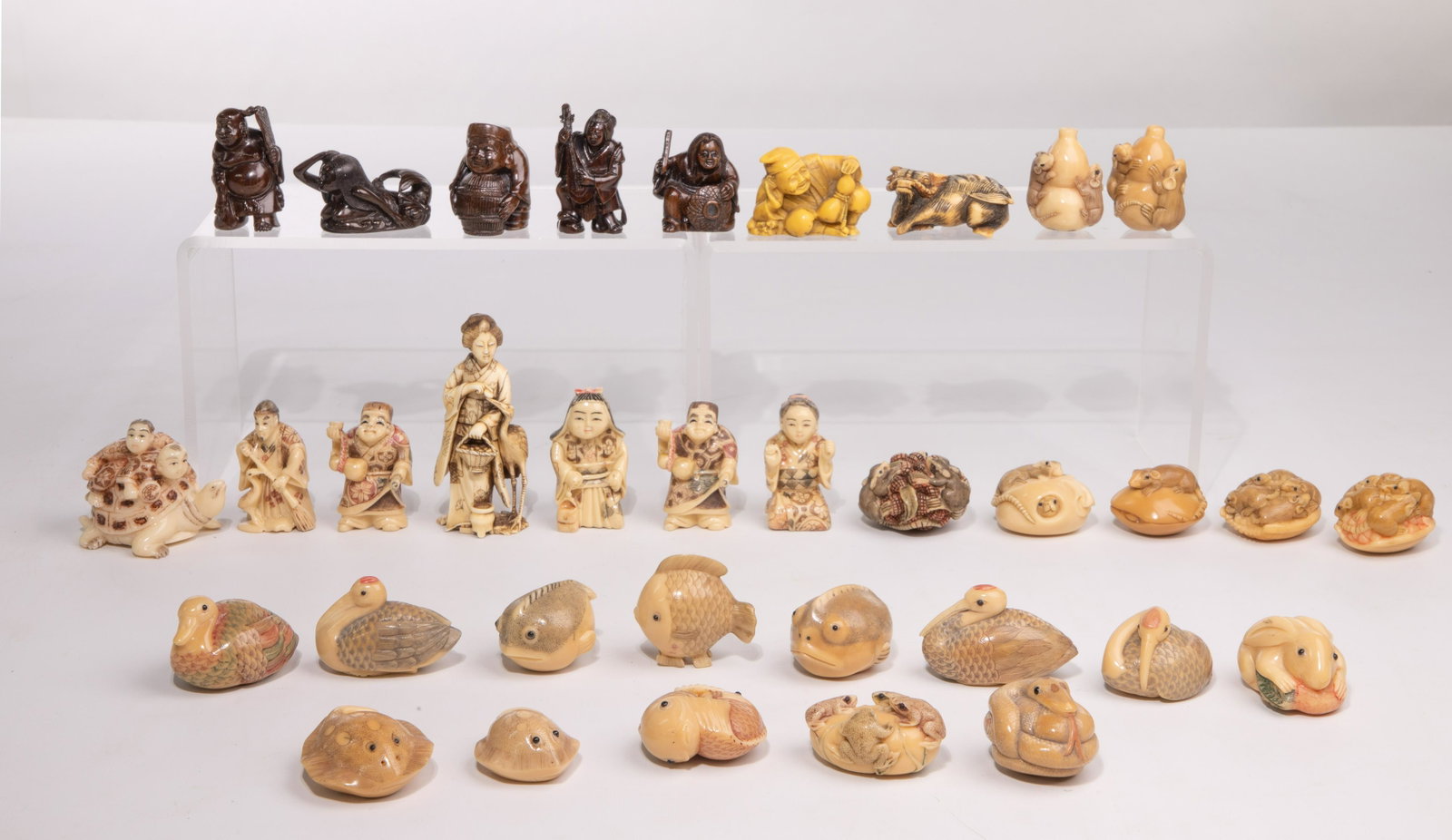 Asian Netsuke and Okimono Figurine Assortment: Asian Netsuke and Okimono Figurine Assortment (34) items including (32) Netsuke style and (2) Okimono style, having various forms with materials including bone, wood, tagua nut and composite; most sig