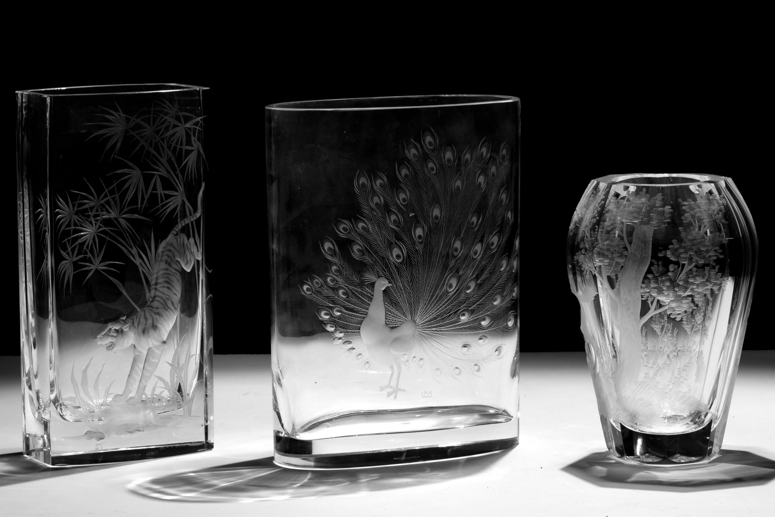 Moser Animal Motif Glass Vase Assortment: Moser Animal Motif Glass Vase Assortment (3) items having etched intaglio decoration including a peacock having engraved monogram 'LM' beneath the peacock with a Moser labeled presentation case; a tig