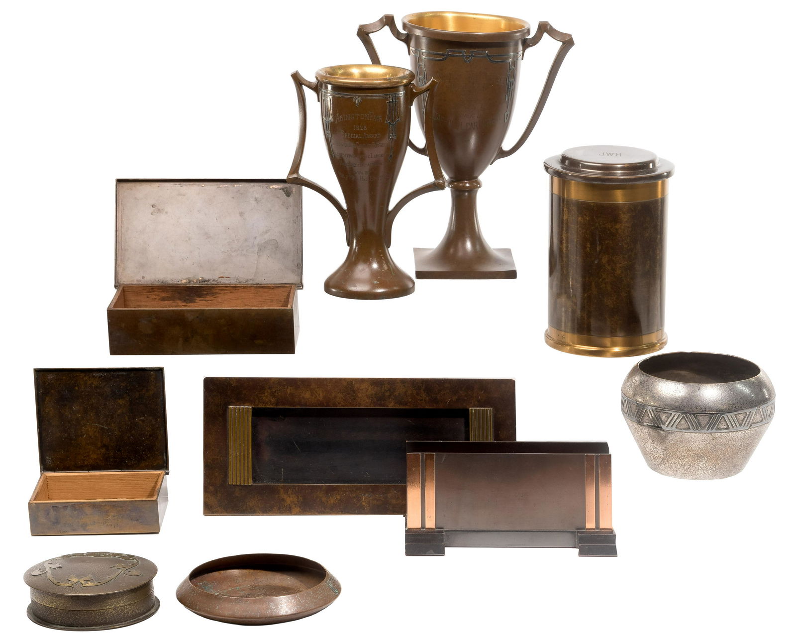 Silvercrest Metal Object Assortment: Silvercrest Metal Object Assortment (10) items including (2) inscribed trophy cups, a bowl and an ashtray having silver overlay on bronze decoration; (2) cigarette boxes, a monogrammed cylindrical hum