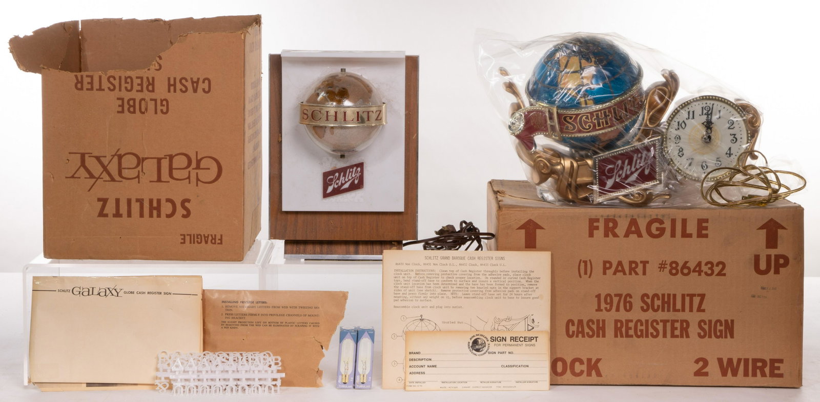 Schlitz Globe Illuminated Motion Cash Register Signs: Schlitz Globe Illuminated Motion Cash Register Signs (2) items including 'Grand Baroque' with clock in original plastic and 'Galaxy Globe' including unused 'privilege letters' in original envelops for