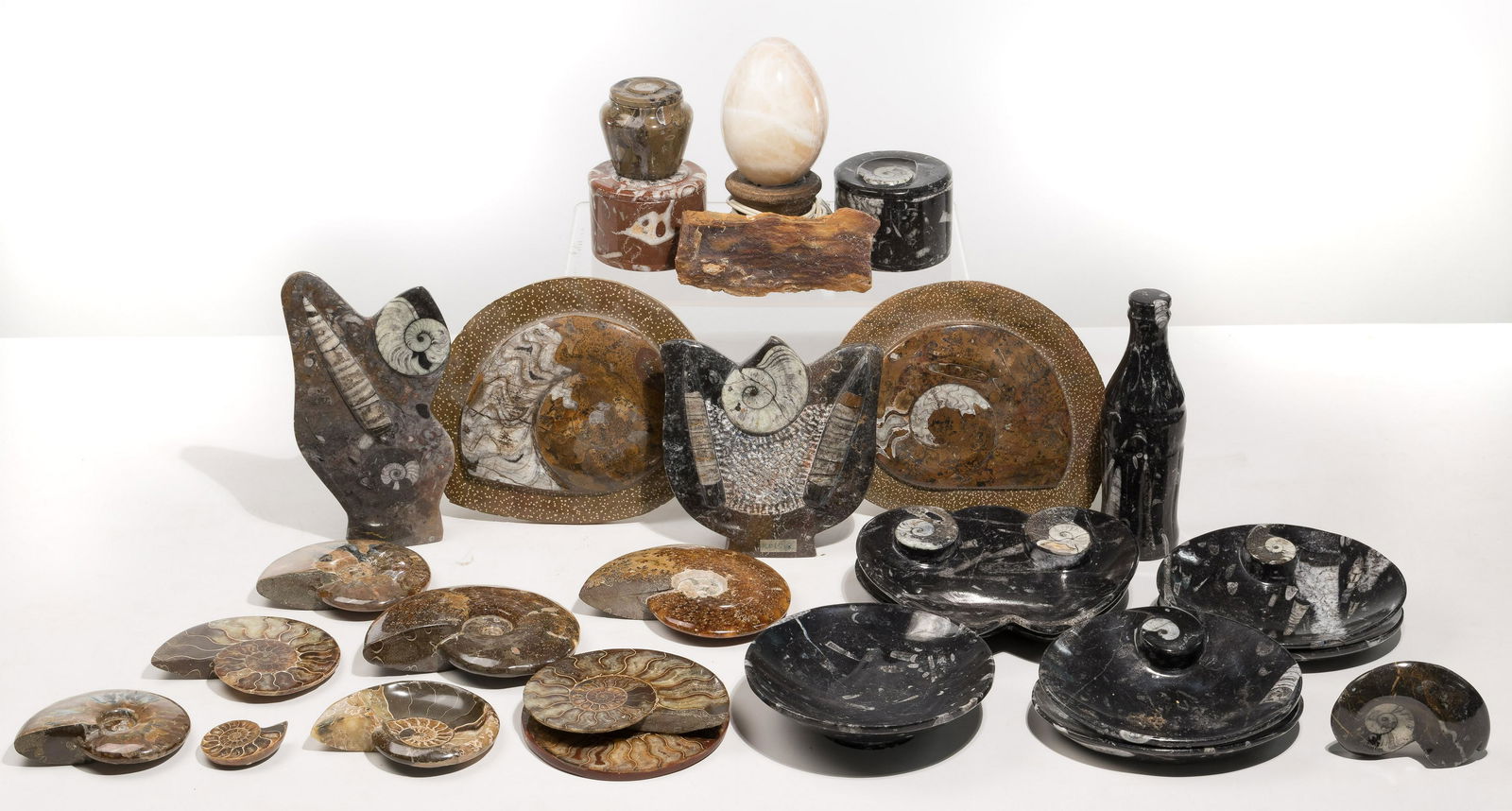 Carved Fossil Assortment: Carved Fossil Assortment Approximately (24) Moroccan ammonite fossils and fossil clusters, having been cut to various sizes and forms including individual / bisected ammonites, coasters, plates, dishe