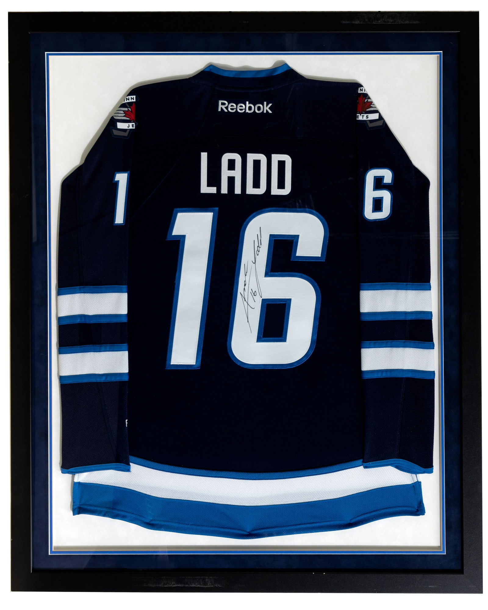 Winnipeg Jets Andrew Ladd Signed Jersey: Winnipeg Jets Andrew Ladd Signed Jersey Reebok, signed on 6, matted in Jets colors and stitch tacked to backboard, wood frame, under glass Property from: an Estate, Lemont, Illinois Height: 43 inches,