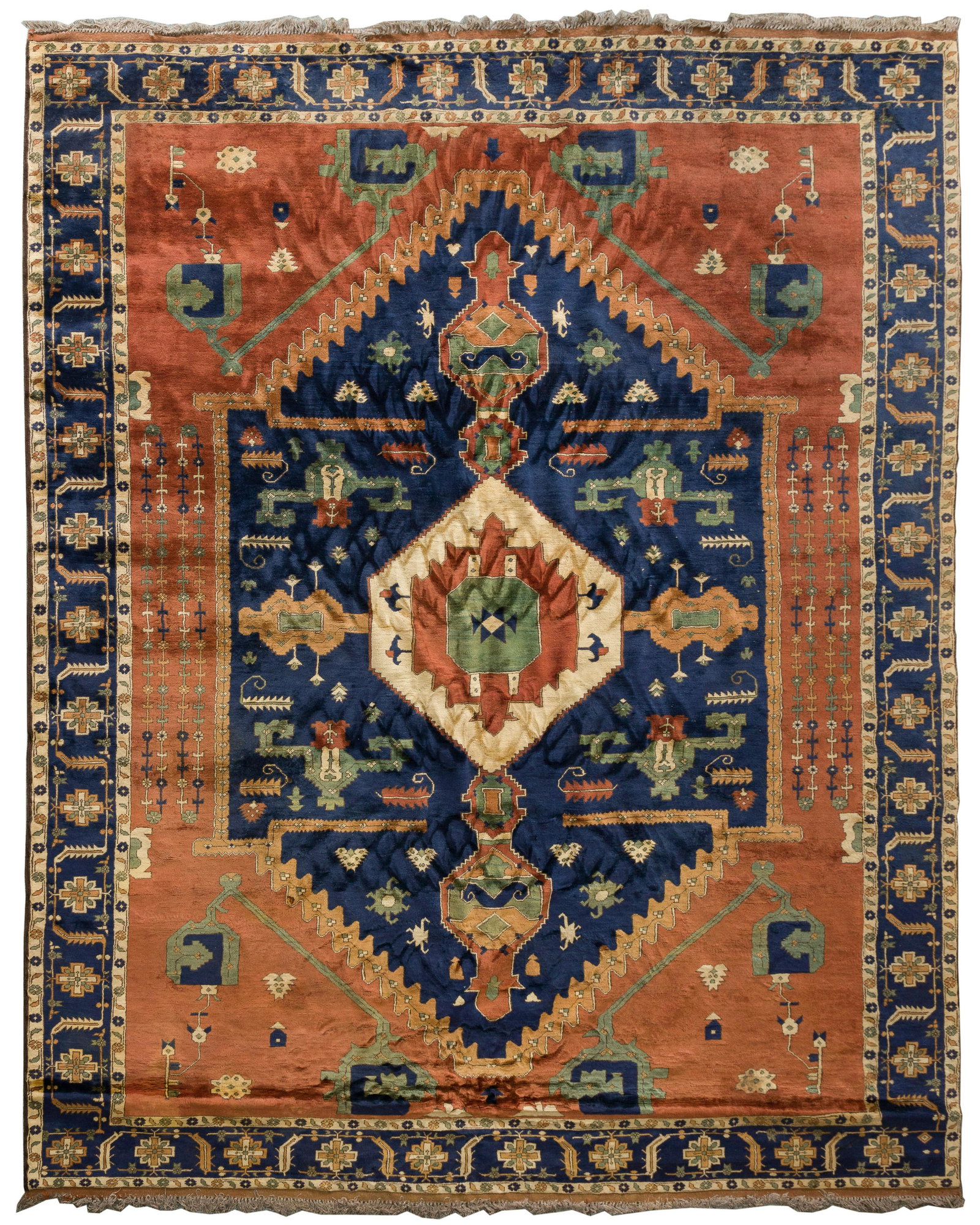 Persian Wool Rug: Persian Wool Rug Hand-knotted, a geometric abstract pattern having a center medallion in hues of rust, green and cream on a blue field, fringe Property from: an Estate, Woodstock, Illinois Length: 144