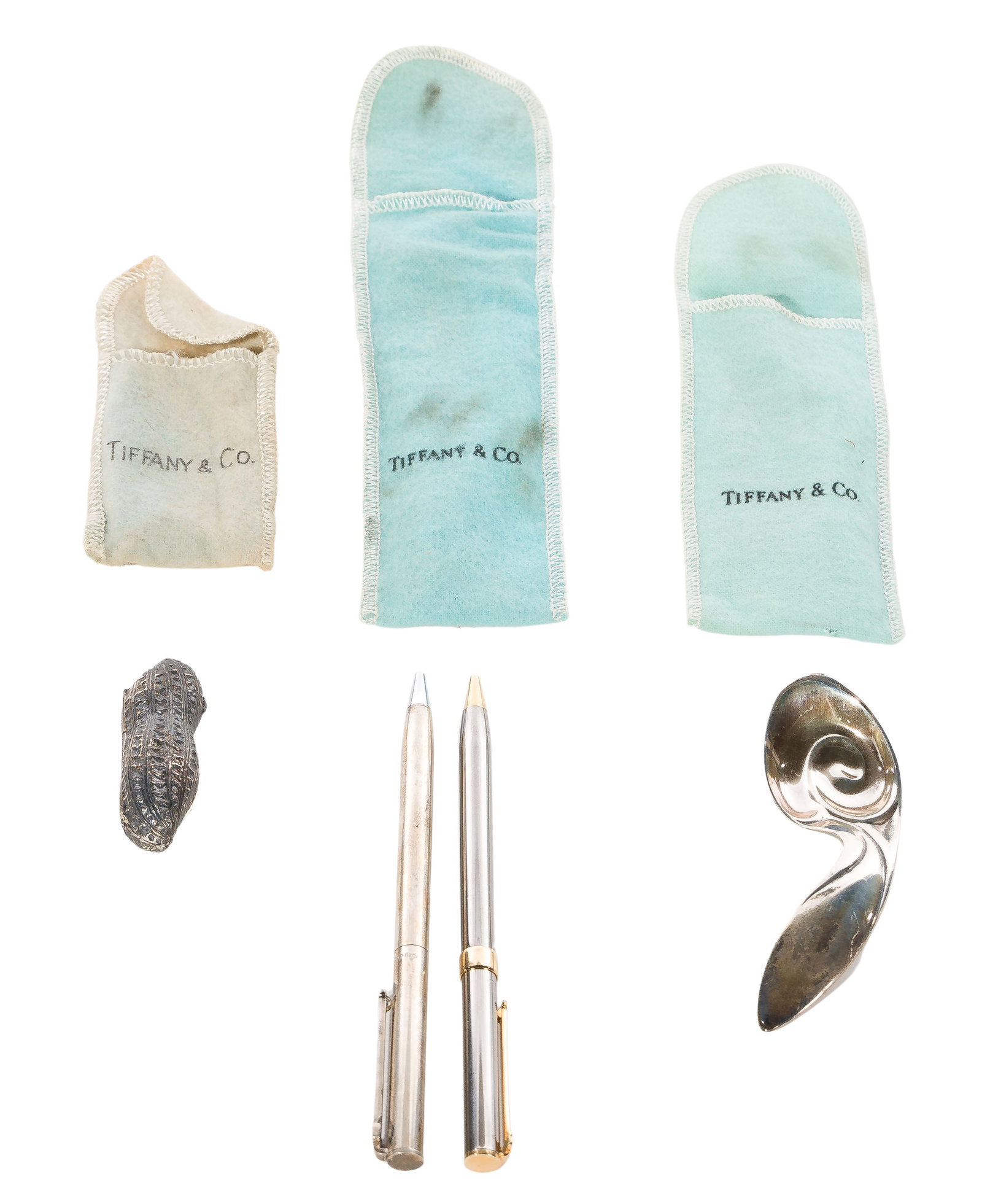 Tiffany & Co Assortment: Tiffany & Co Assortment (3) items including a hinged peanut pill box, a baby spoon and a pen, all marked 'Tiffany'; together with a steel pen having gold-tone accents Property from: an Estate, Chicago