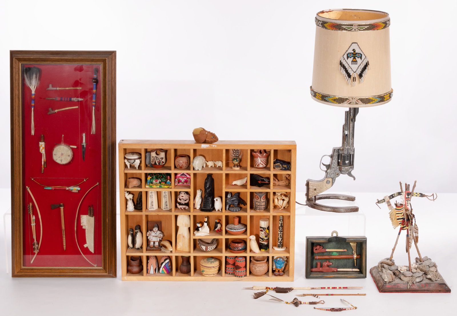 Native American and Southwest Assortment: Native American and Southwest Assortment Including a open shadow box containing small pottery and hand carved figurines, a framed montage of miniature weapons and ceremonial objects and a lamp crafted