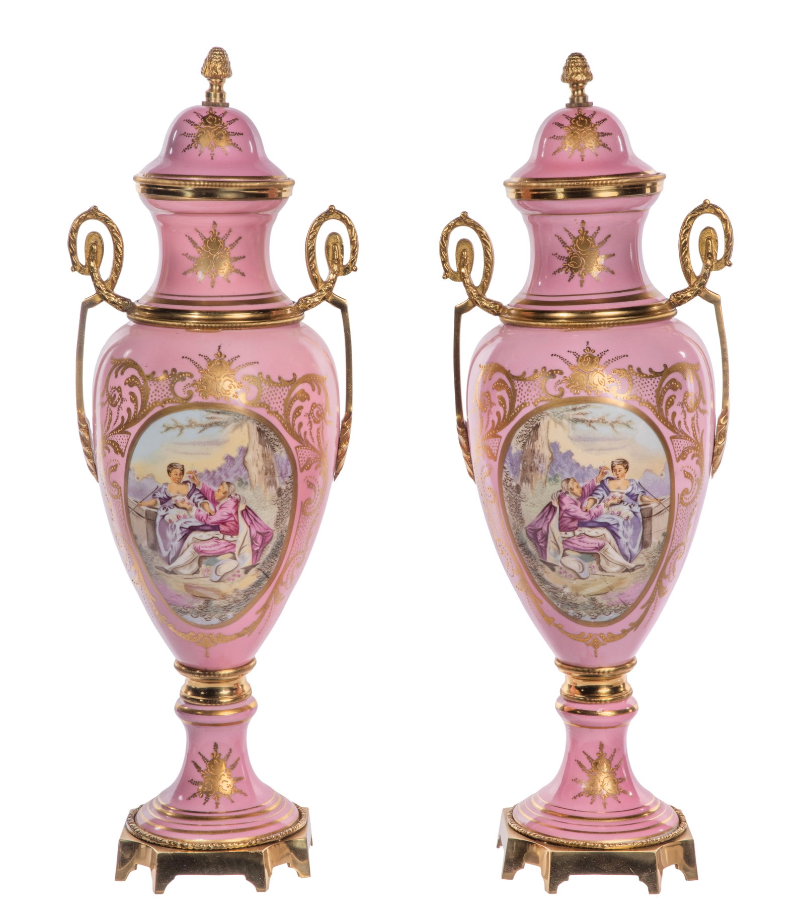 French Bronze Mounted Porcelain Urns: French Bronze Mounted Porcelain Urns Pair of 20th century pink and gilt porcelain lidded urns having a hand painted cartouche on front and brass handles Property from: an Estate, Crown Point, Indiana 
