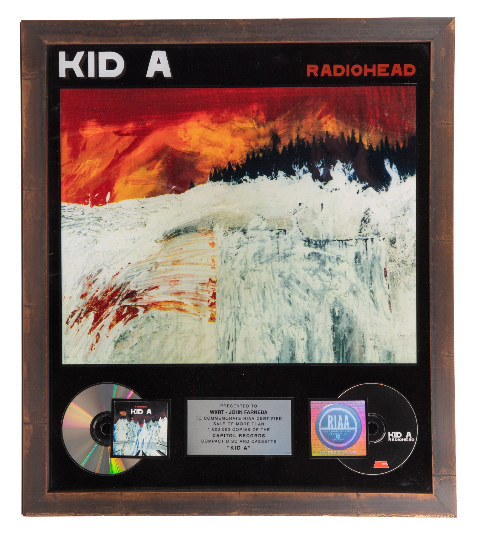 Radiohead 'Kid A' 1-Million Sales Award: Radiohead 'Kid A' 1-Million Sales Award Having a shadow box containing compact discs and plaque inscribed to 'WXRT', float mounted in a wood frame Property from: a Private Collector, Chicago, Illinois