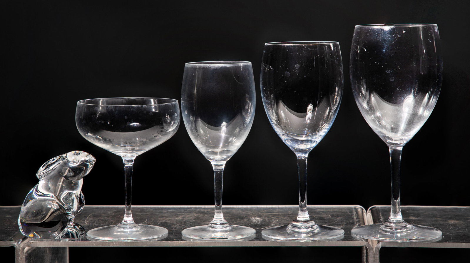 Baccarat Degustation Grand Bordeaux Stemware: Baccarat Degustation Grand Bordeaux Stemware (25) total items including (8) 7.25-inch, (7) 6.625-inch, (6) 5.875-inch wine glasses and (3) champagne coupes; together with a clear seated rabbit paperwe