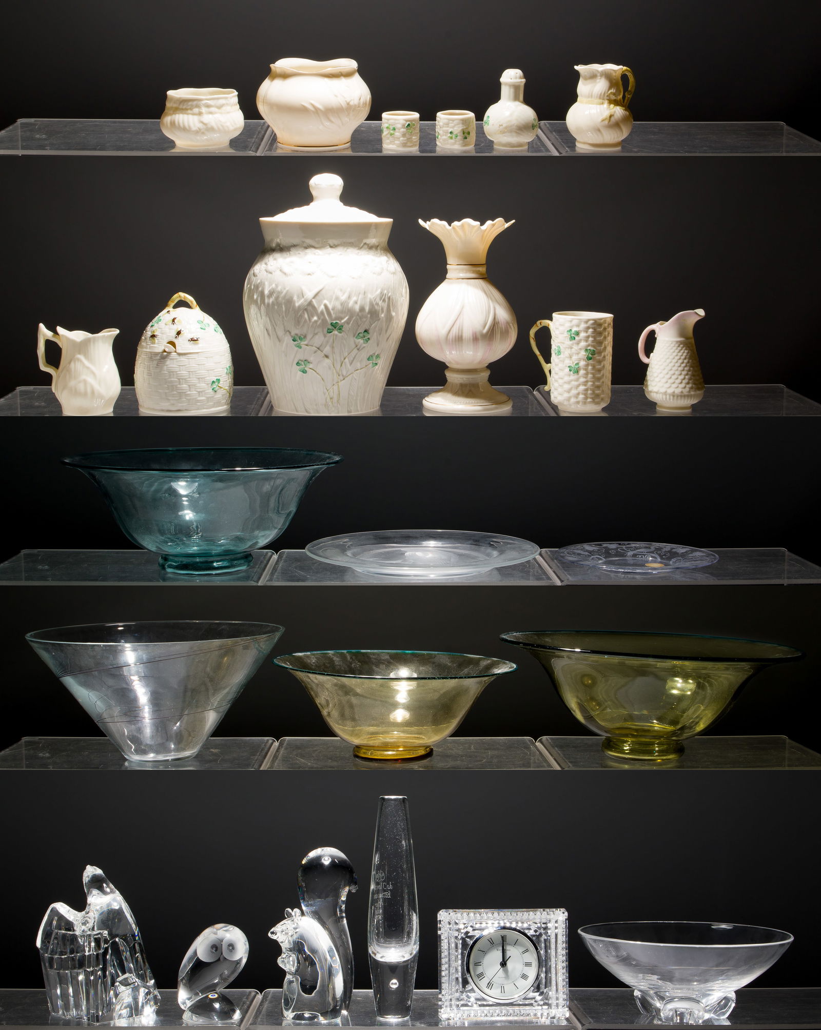 Steuben and Belleek Assortment: Steuben and Belleek Assortment (24) items including (12) Steuben figurines, vases, clocks, bowls, most marked, and (12) Belleek bowls, vase, napkin rings, creamers and sugar in white and shamrock desi