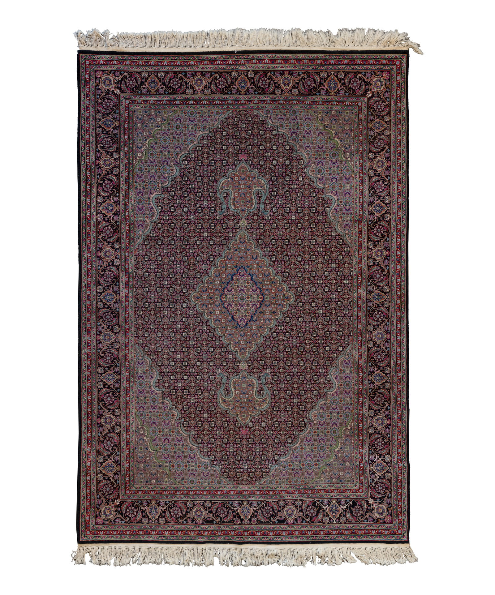 Tabriz Wool Rug: Tabriz Wool Rug A hand woven rug having a center medallion and an abstract geometric motif in hues of blue, cranberry, green and purple on a black ground Property from: an Estate, Northbrook, Illinois