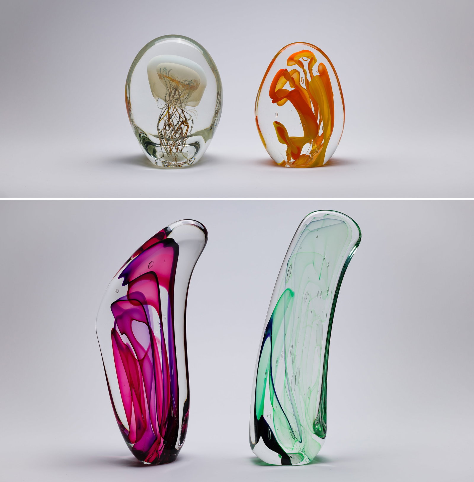 Art Glass Assortment: Art Glass Assortment (4) undated items, unsigned, including (2) oval shaped, and (2) elongated flat front, all having color threads throughout, one oval appearing to be a jelly fish Property from: a P