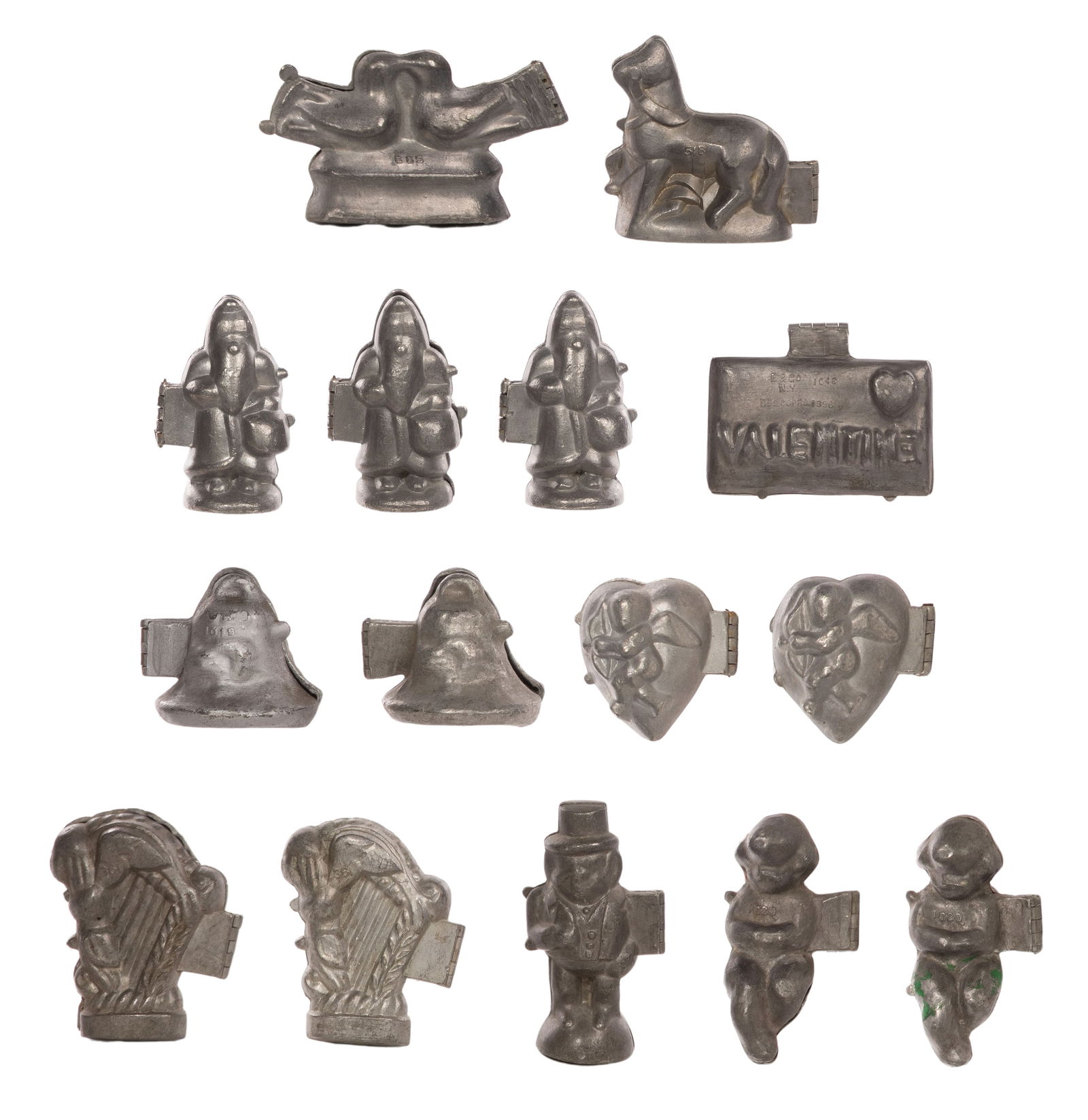 Pewter Holiday Themed Chocolate and Ice Cream Molds: Pewter Holiday Themed Chocolate and Ice Cream Molds (15) items including Santa and Valentine's Day, some marked 'E&Co.' for Eppelsheimer & Co Property from: an Estate, Chicago, Illinois Height: 3 1/4