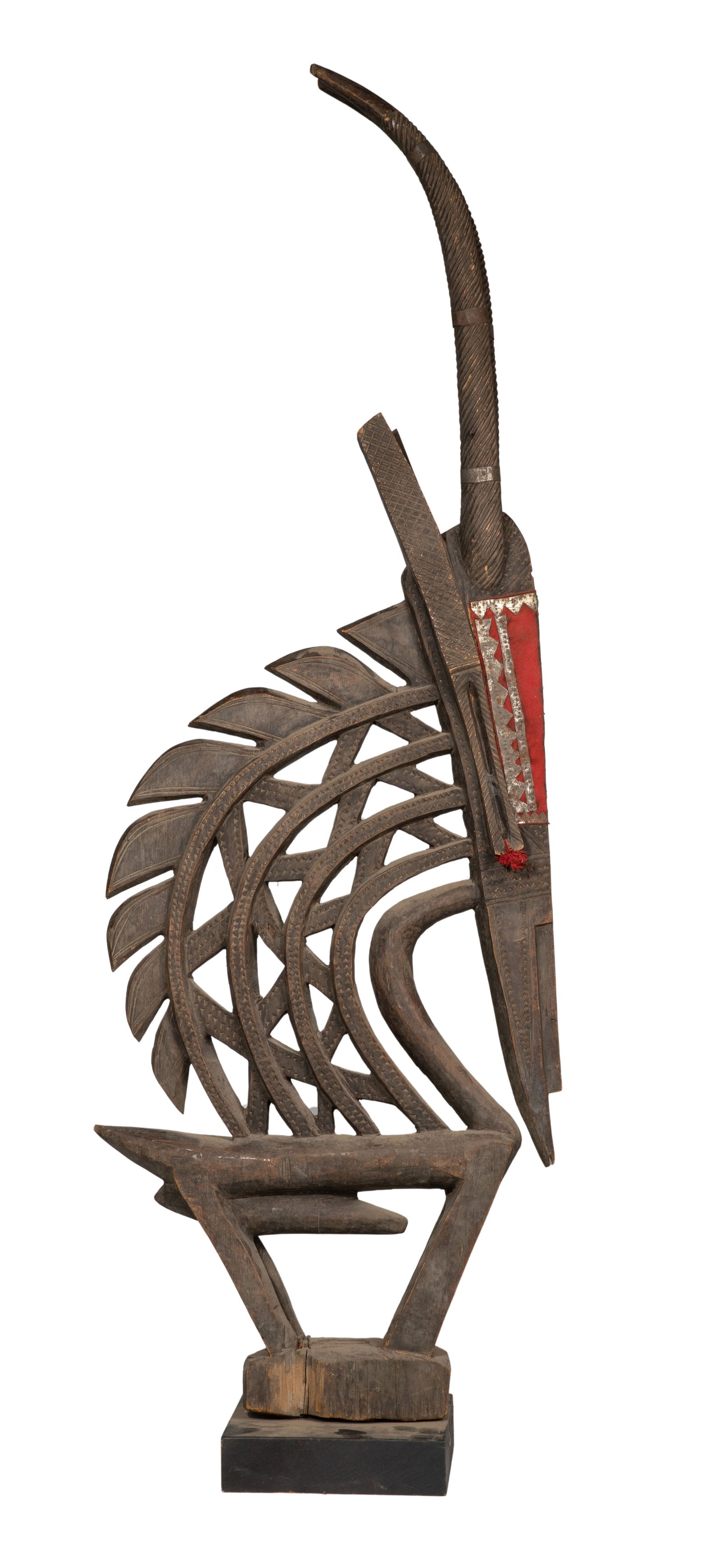 African Chiwara Bamana Antelope Headdress: African Chiwara Bamana Antelope Headdress Ceremonial carved wood, metal, nails, leather, fibers on a wood base Property from: an Estate, Chicago, Illinois Height: 51 inches, Width: 18 inches, Depth: 8
