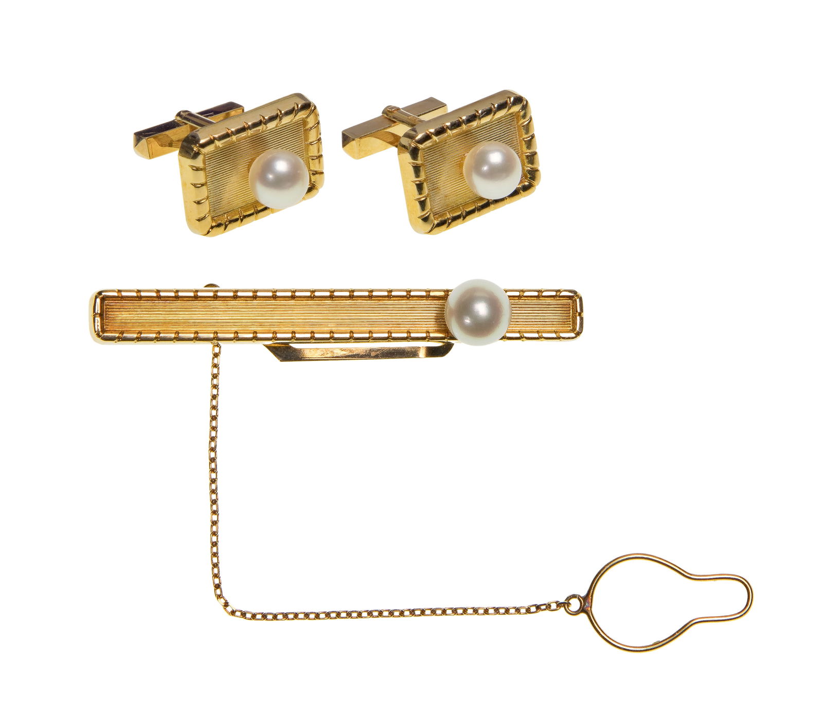 18k Yellow Gold and Pearl Cufflink and Tie Clip Set: 18k Yellow Gold and Pearl Cufflink and Tie Clip Set Each having an approximately 7mm pearl (all marked 'K18'), with storage box Property from: a Private Collector, Elmhurst, Illinois Height: 1/4 inche