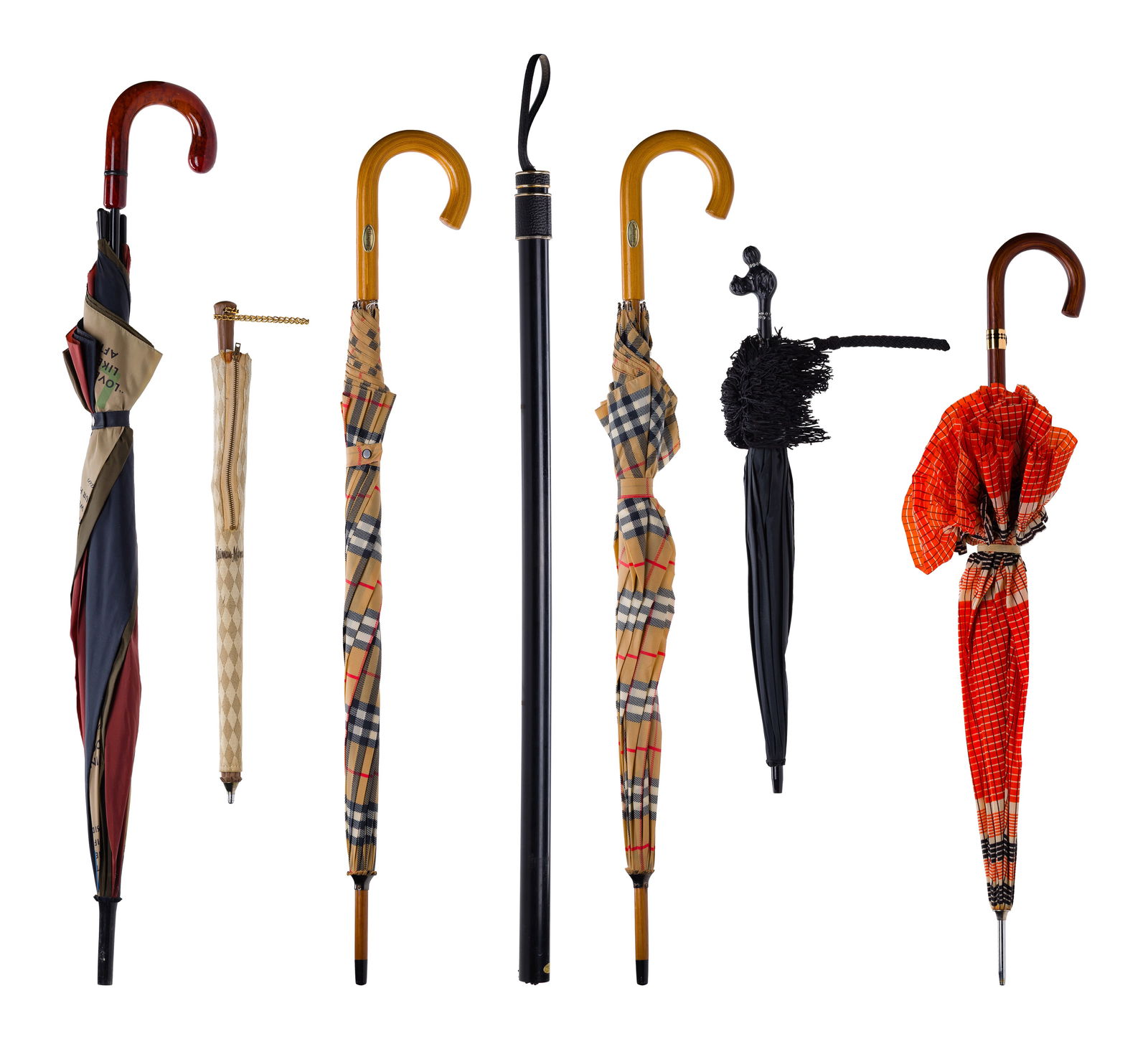 Designer Umbrella Assortment: Designer Umbrella Assortment (7) items including (2) Burberry plaid walking, a Neiman Marcus, an Aramis, a Marco Polo Ltd. walking stick style, an unmarked rhinestone set poodle head handle having