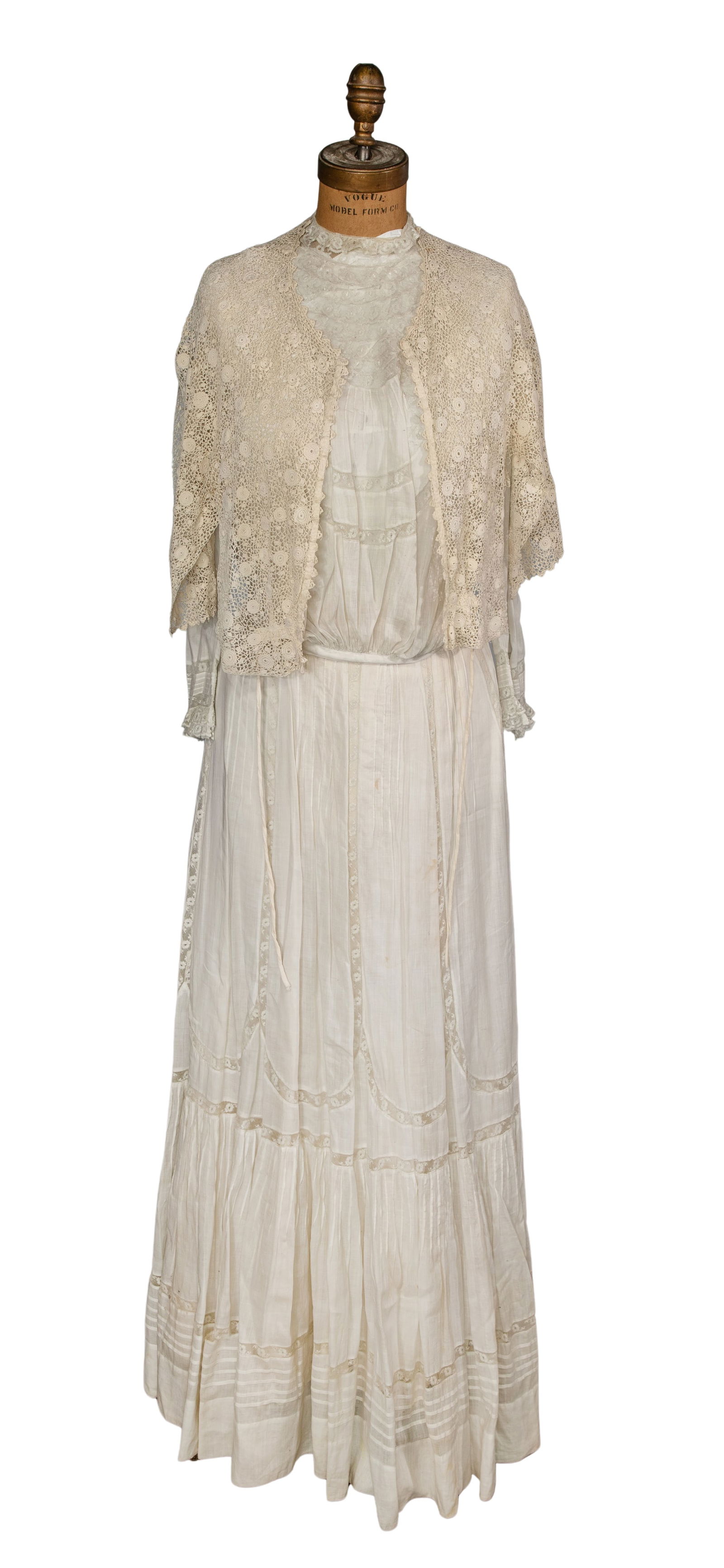 Dress Form and Edwardian Dress: Dress Form and Edwardian Dress A dress form mannequin having a fabric-covered torso, cast iron base and casters, marked 'American Model Form Co' and 'Vogue' as well as a white Edwardian linen lawn