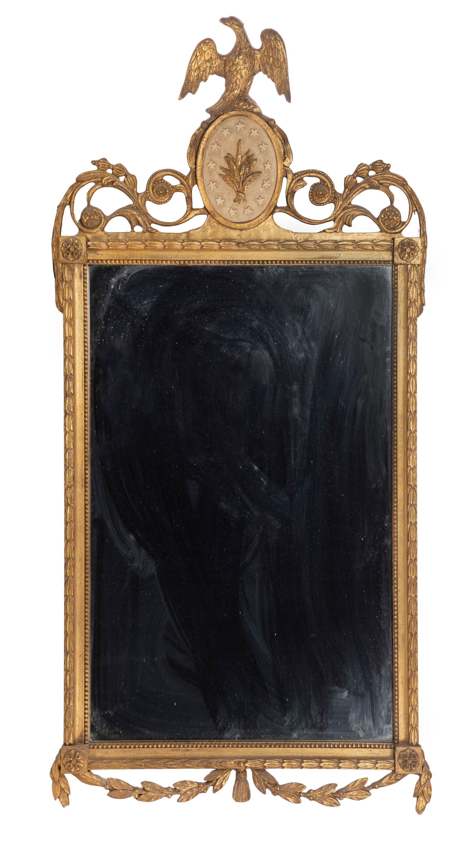 Friedman Brothers Federal Style Mirror: Friedman Brothers Federal Style Mirror Early 20th century, gold-tone composite on carved wood frame surmounted by an eagle perched on a scroll supported star-spangled cartouche, a paper label of F